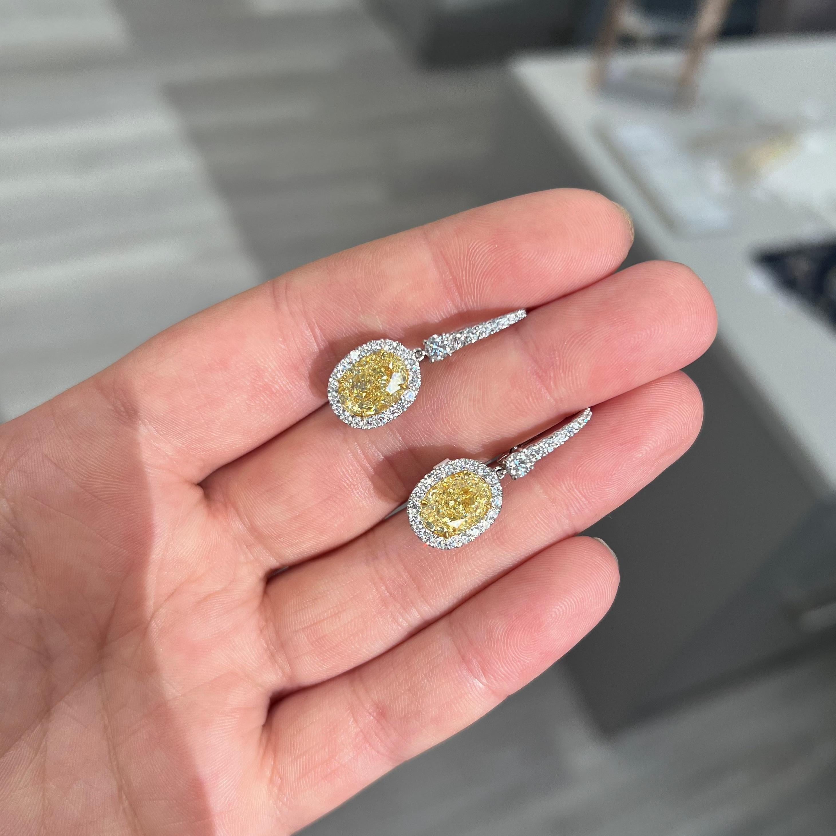 Drop dead gorgeous earrings with 3ct each GIA certified Fancy Light Yellow Ovals bursting with fire and life
Strong lemon yellow color, no bow tie- color filling the entirety of the stones
Set in Platinum and 18kt Yellow Gold with 1.09ct of white