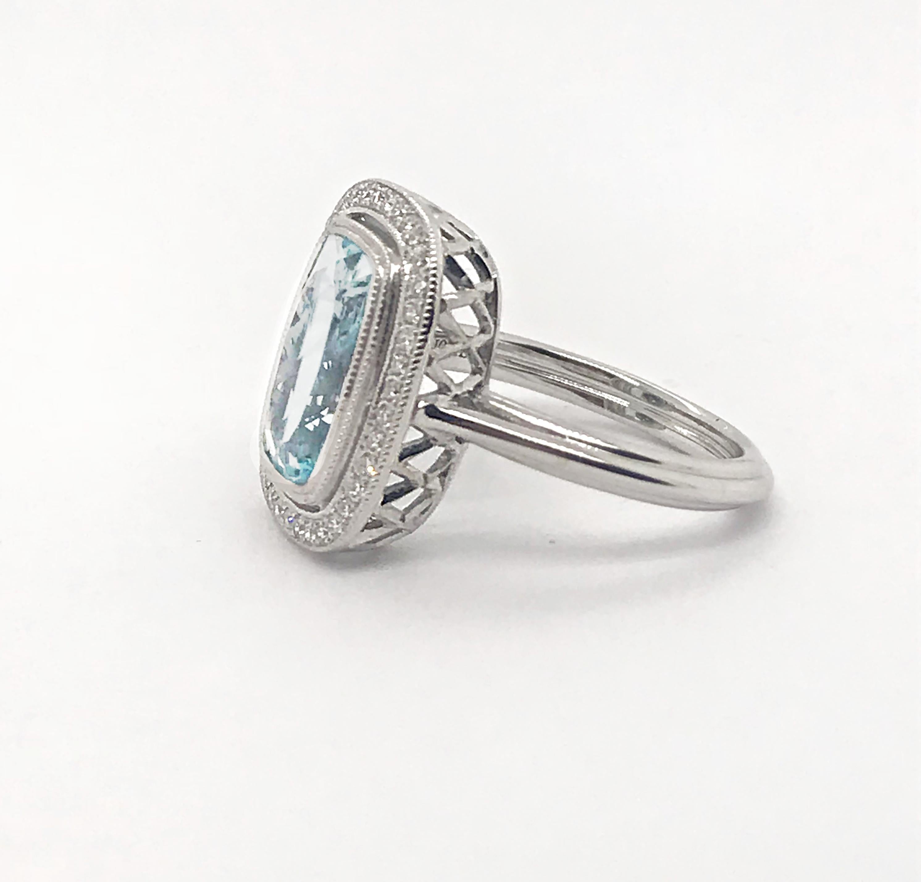 This exquisite Cushion Cut Aquamarine is 3.04 carats and set in this custom 14kt White Gold Setting. There are thirty-eight (38) round brilliant cut diamonds that total .19 carats. The setting is detailed with hand completed milgrain edge detail.  
