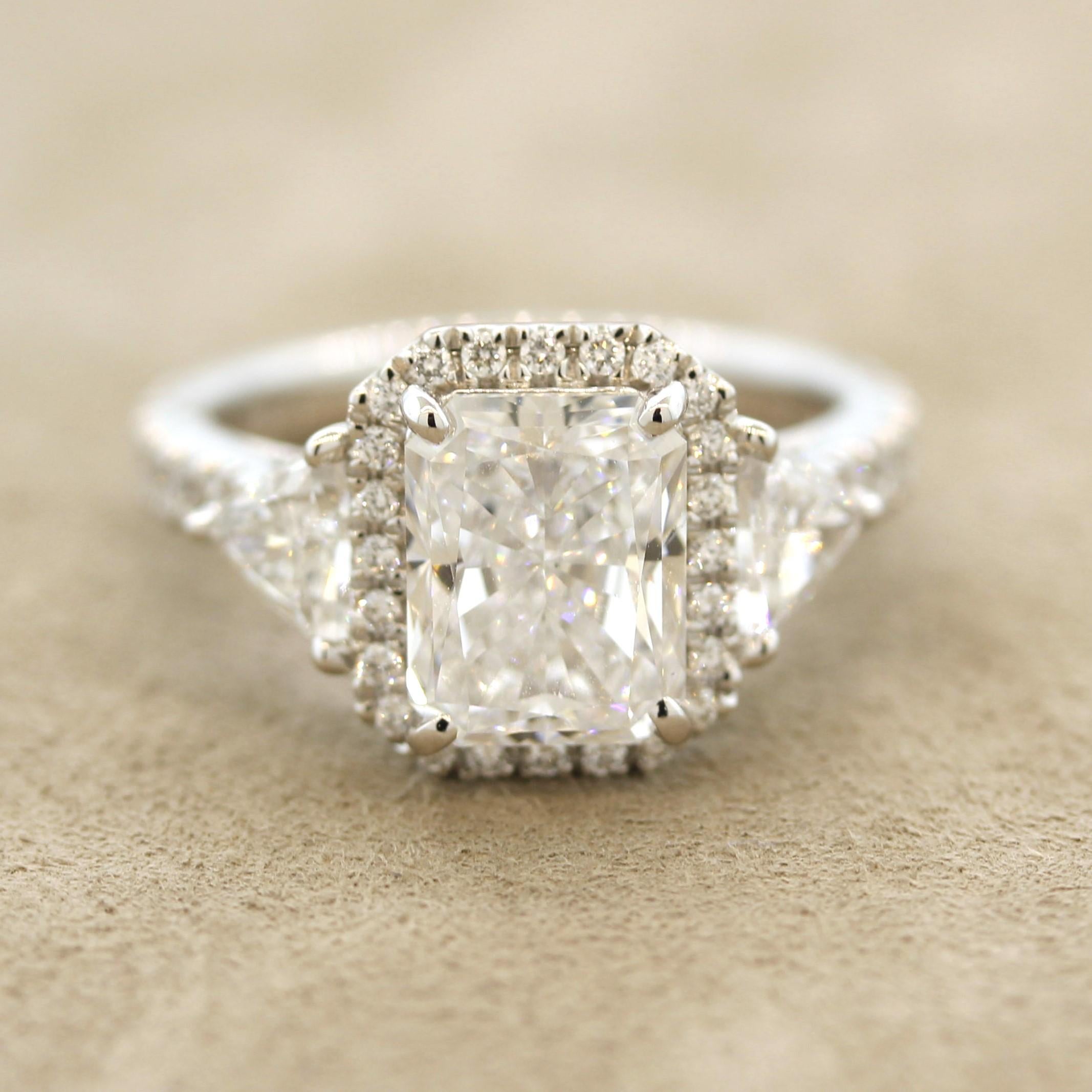 As good as it gets! A 3.04 carat radiant-cut diamond mains this lovely platinum made ring. It has a D color grade and IF (internally flawless) clarity grade making this diamond extremely pure, clean, and white! It is complemented by two