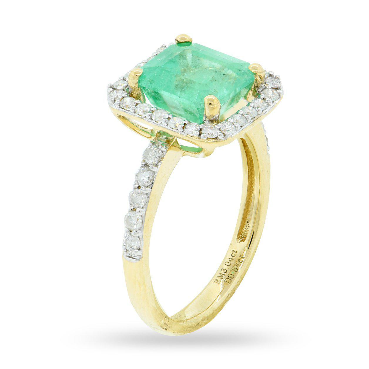 One electronically tested 14KT yellow gold ladies cast emerald and diamond ring. The featured emerald is set within a diamond bezel supported by diamond set shoulders, completed by a two and one-half millimeter wide band. Bright polish finish with