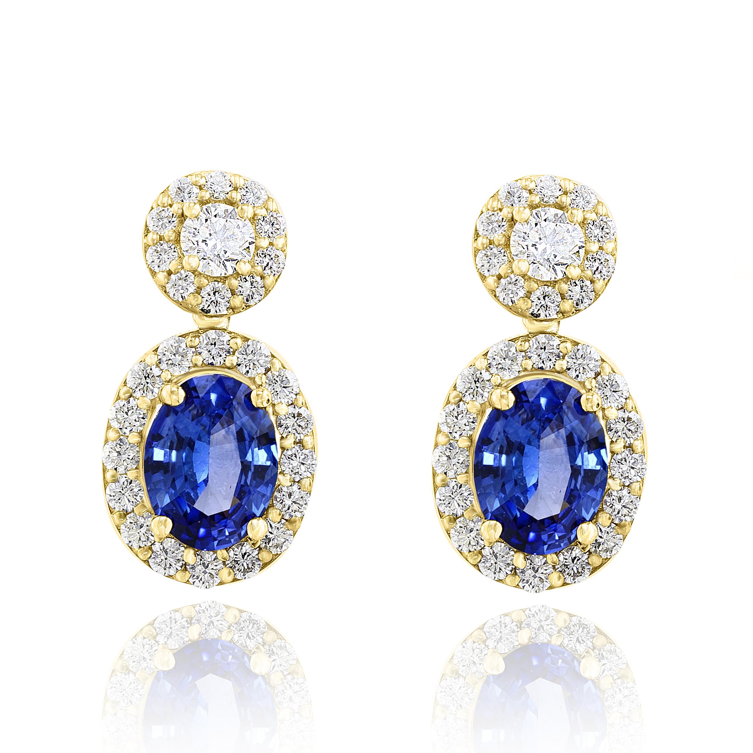 A beautiful and chic pair of drop earrings showcasing brilliant-cut diamonds, and oval shaped Blue Sapphires set in an intricate and stylish design. 2  Diamonds on the top weigh 0.36 carats in total.  2  Blue sapphires weigh 3.04 carats in total.