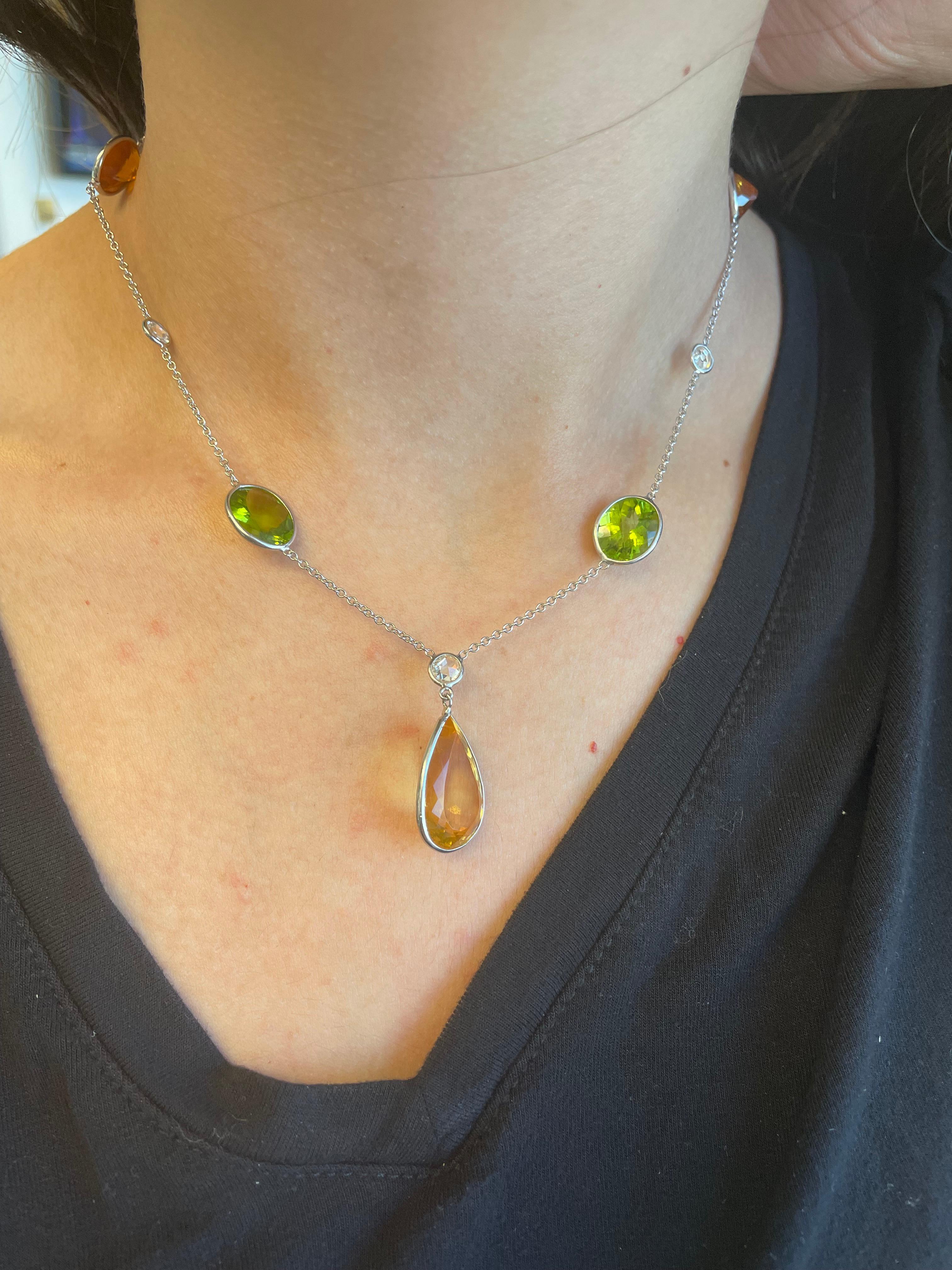 Beautiful mixed colored stone drop necklace.
30.49 carats total gemstone weight.
3 citrine quartz, 1 pear shape, 2 rounds, 20.15 carats. 2 rose cut peridot, 9.25 carats. 3 round brilliant diamonds, 1.09 carats. Approximately H/I color and SI