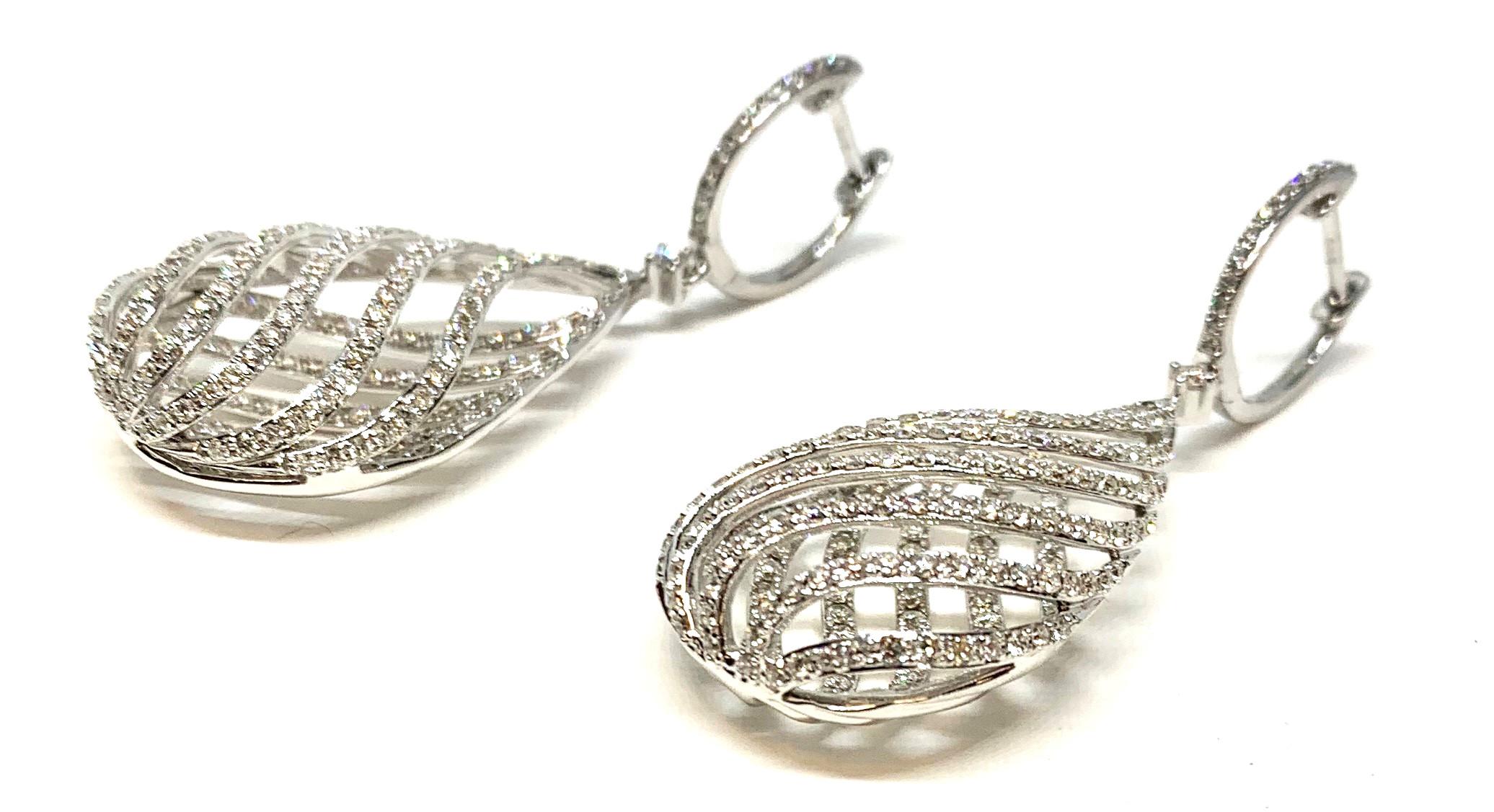These large, pillowy, lattice design earrings are made of 18k white gold with lever backs and are set with over 3 carats of round brilliant cut diamonds. They are breathtaking, with an elegant and airy design makes them surprisingly lightweight and