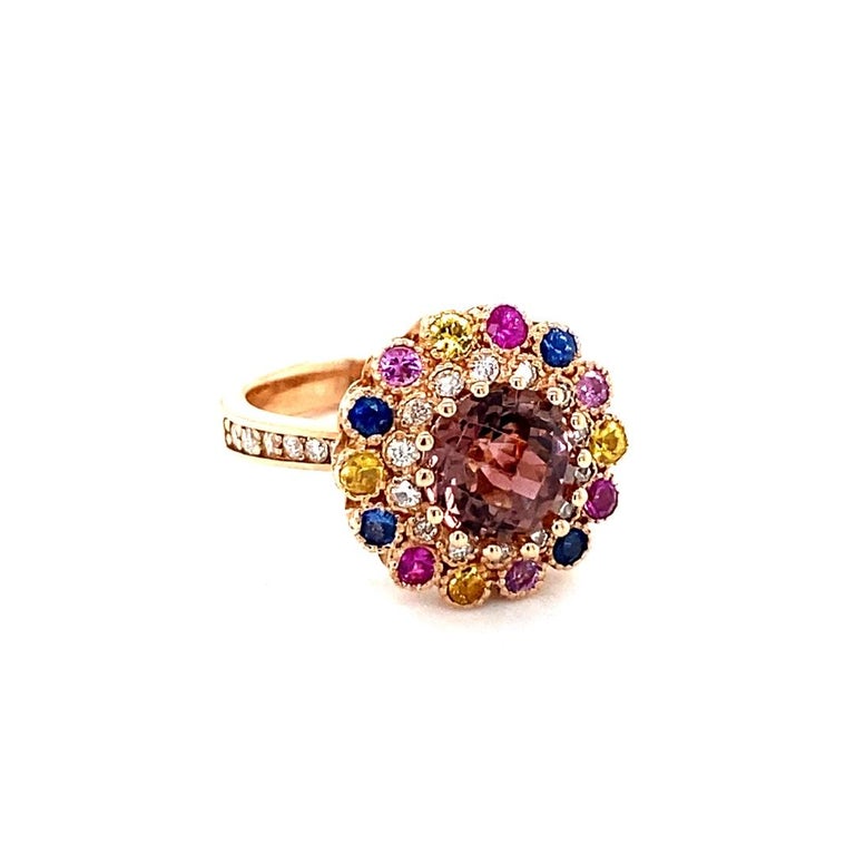 3.05 Carat Natural Tourmaline Sapphire Diamond Rose Gold Cocktail Ring

This Ring has a Round Checkered Cut Tourmaline that weighs 1.90 carats and 14 Multi Sapphires that weigh 0.79 Carats. There are also 26 Round Cut Diamonds that weigh 0.36