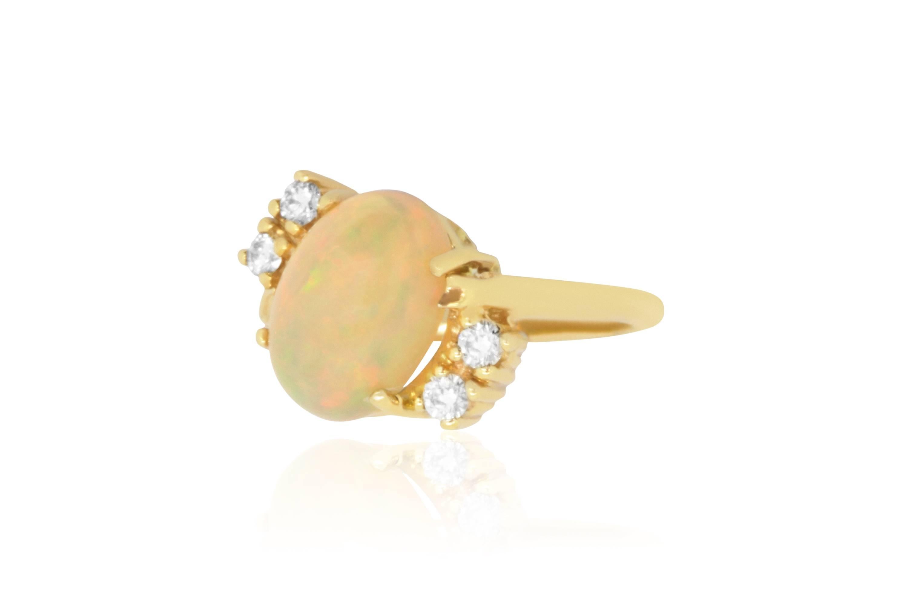 A breathtaking piece, this fabulous ring features a 3.05 Carat Oval Opal stone weighing in at 3.70 grams. It is surrounded by 4 round diamonds in an exquisite, one-of-a-kind setting. With it's incredible quality and stunning design, you know it's