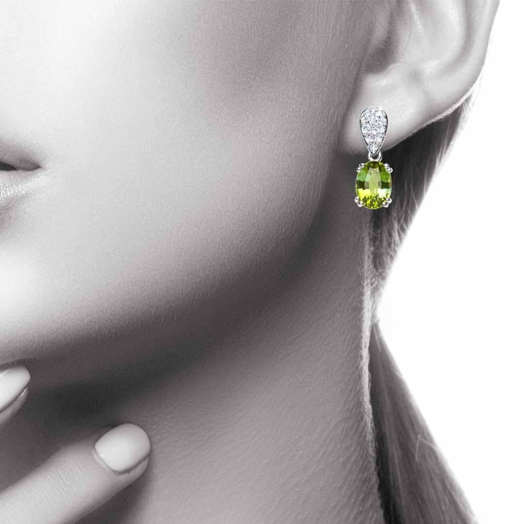 These earrings showcase beautiful oval green tourmalines offset beautifully by pear shaped diamond pave set fittings. Simply stunning! The Tourmalines weigh a total of 3.05 carat and the total diamond weight is 0.15 carat, Colour G, Clarity