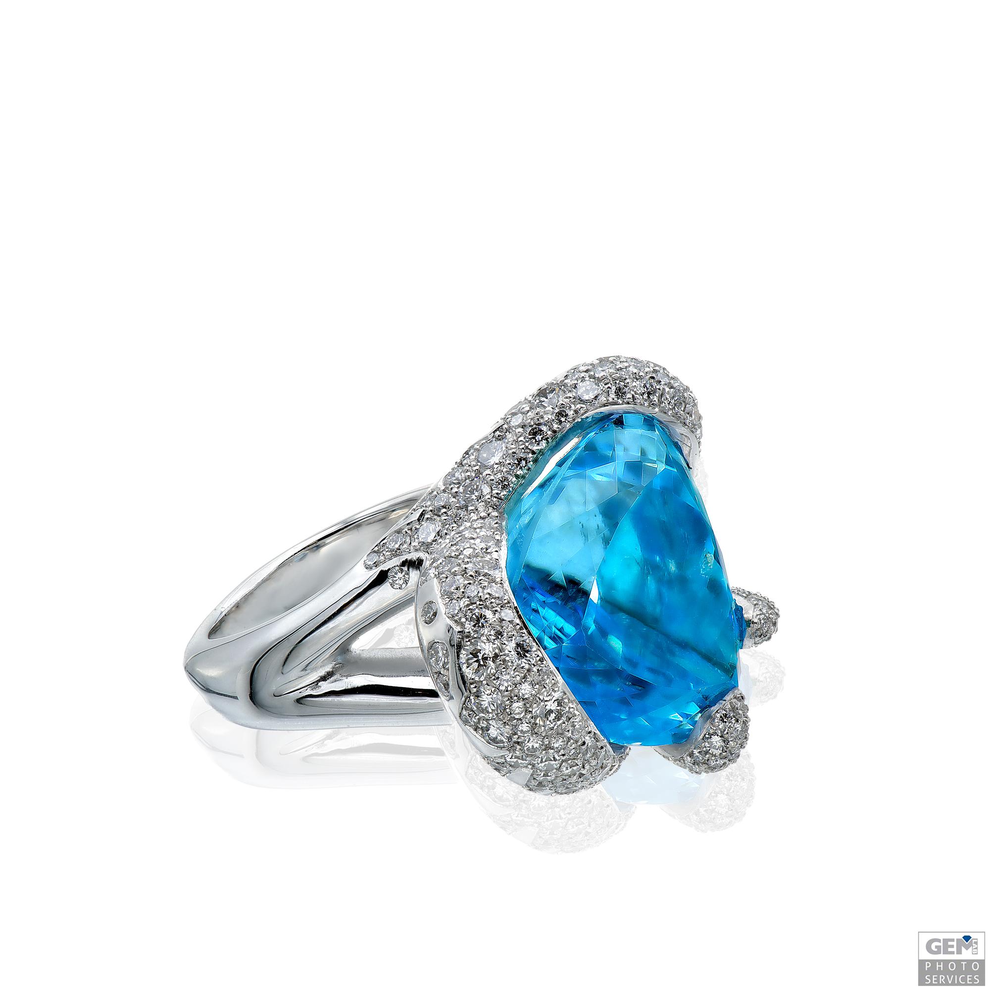 This bold Carigi design boasts an amazing trillion cut light blue 30,59ct Topaz centerstone. The blue Topaz sparkles in an 18k white golden ring, set with small diamonds for a total of 2,75ct. The design was created and based upon big tentacles
