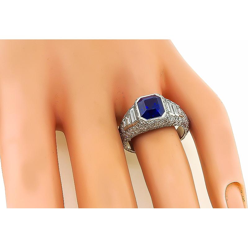This is a fabulous platinum engagement ring. The ring is centered with a lovely emerald cut Ceylon sapphire that weighs approximately 3.05ct. The sapphire is accentuated by sparkling round and baguette cut diamonds that weigh approximately 1.20ct.
