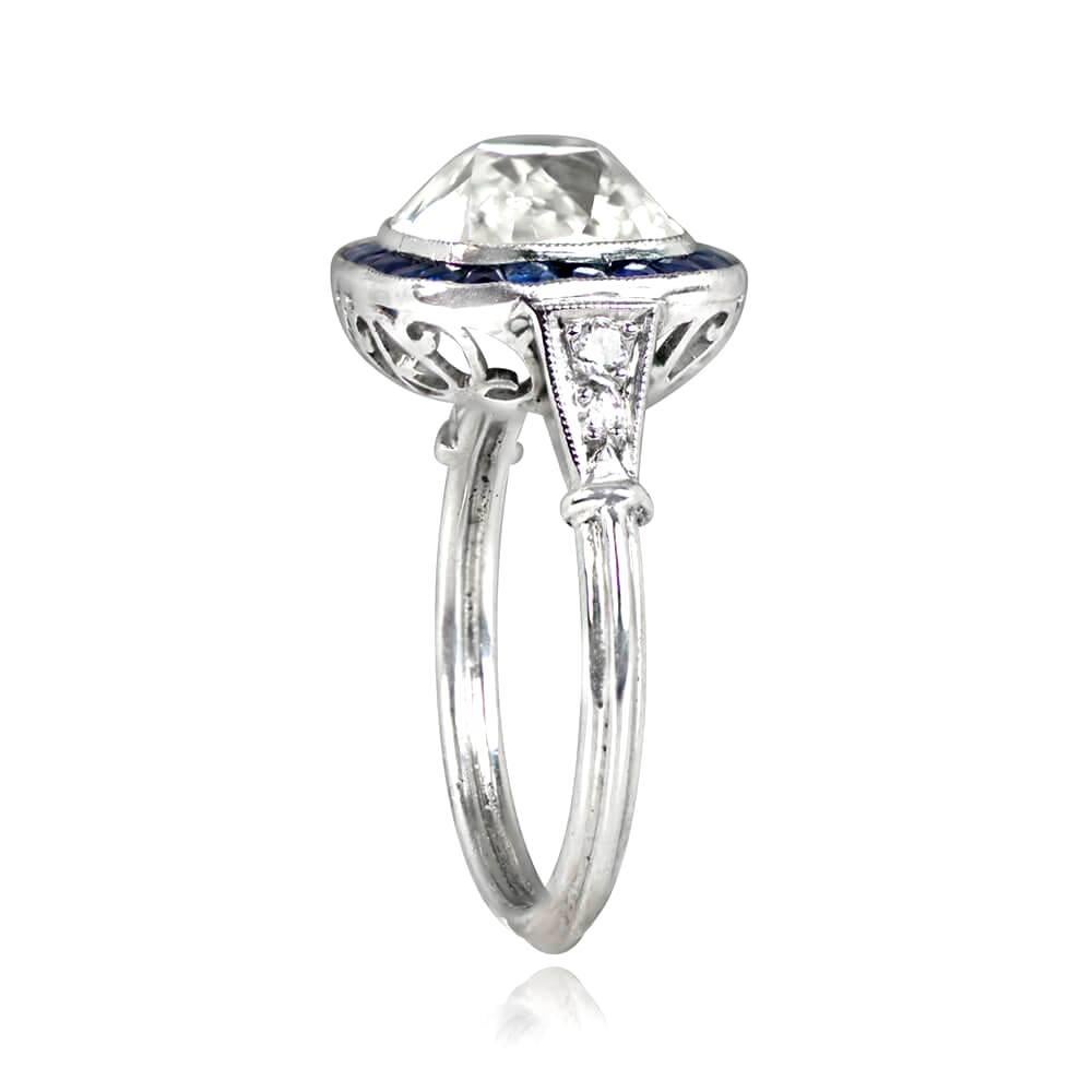 This is stunning halo engagement ring with a 3.05-carat emerald cut diamond (L/VS1) in milgrain bezel. Accented by 2 baguette-cut diamonds, a halo of French-cut sapphires, and old European cut diamonds on the shoulders. Handcrafted in platinum with