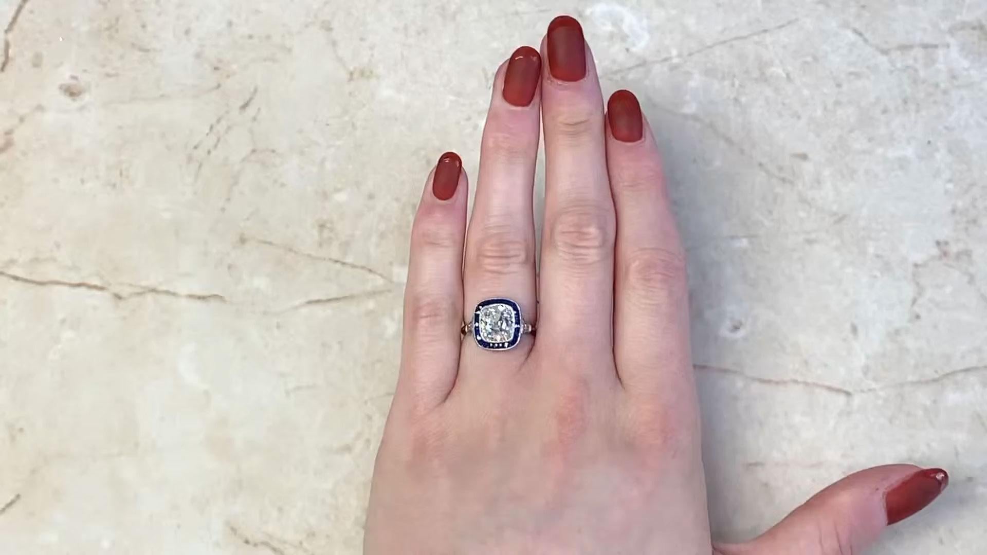 This exquisite halo ring centers a breathtaking antique cushion-cut diamond weighing Approx. 3.00-Carats, graded K color and VS2 clarity. The diamond’s warm hue and exceptional clarity offer a timeless brilliance, while its antique cut brings a
