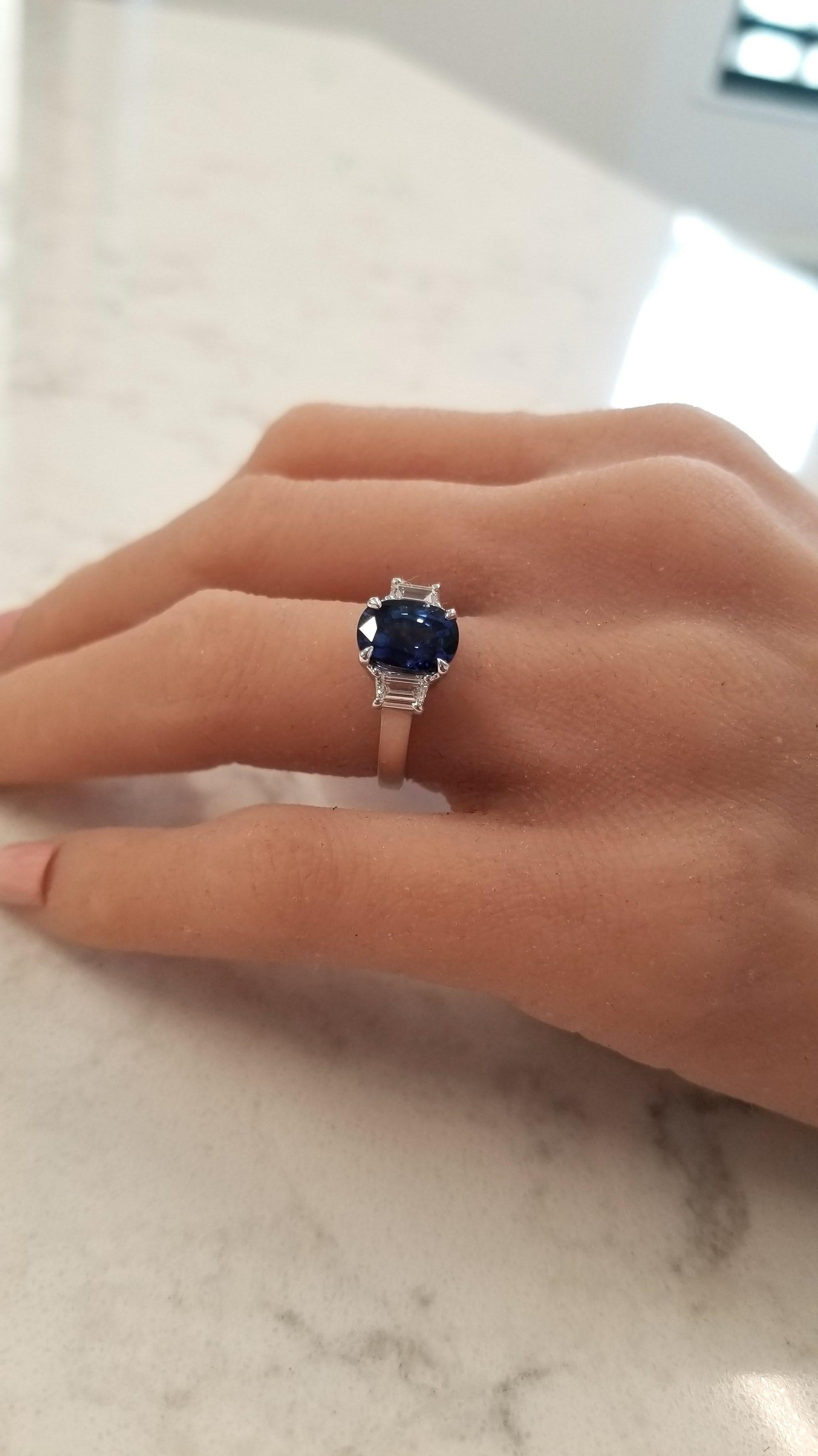 This is a 3.06 carat cushion cut sapphire that takes center stage on this lavish ring. The gem source is Sri Lanka; its color saturation is royal blue; its luster and transparency is excellent. It measures 9.5x7.5mm. Two step-cut trapezoid cut