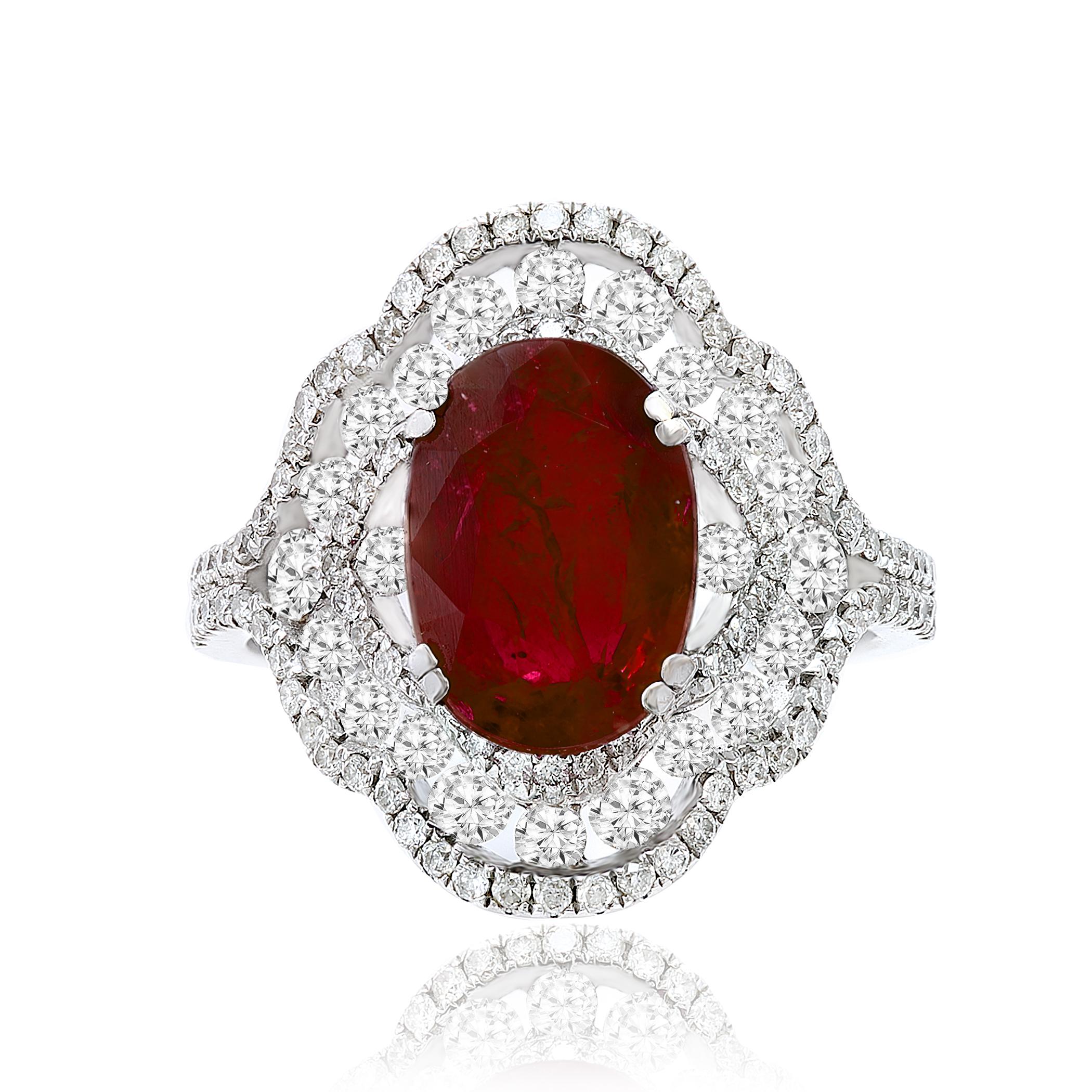 A stylish cocktail ring showcasing a 3.06 carat color-rich ruby, surrounded by rows of round brilliant diamonds. Flanked on either side by a round brilliant diamond. Diamonds weigh 1.26 carats total. Made in 18k white gold.

Size 6.5 US (Sizable).