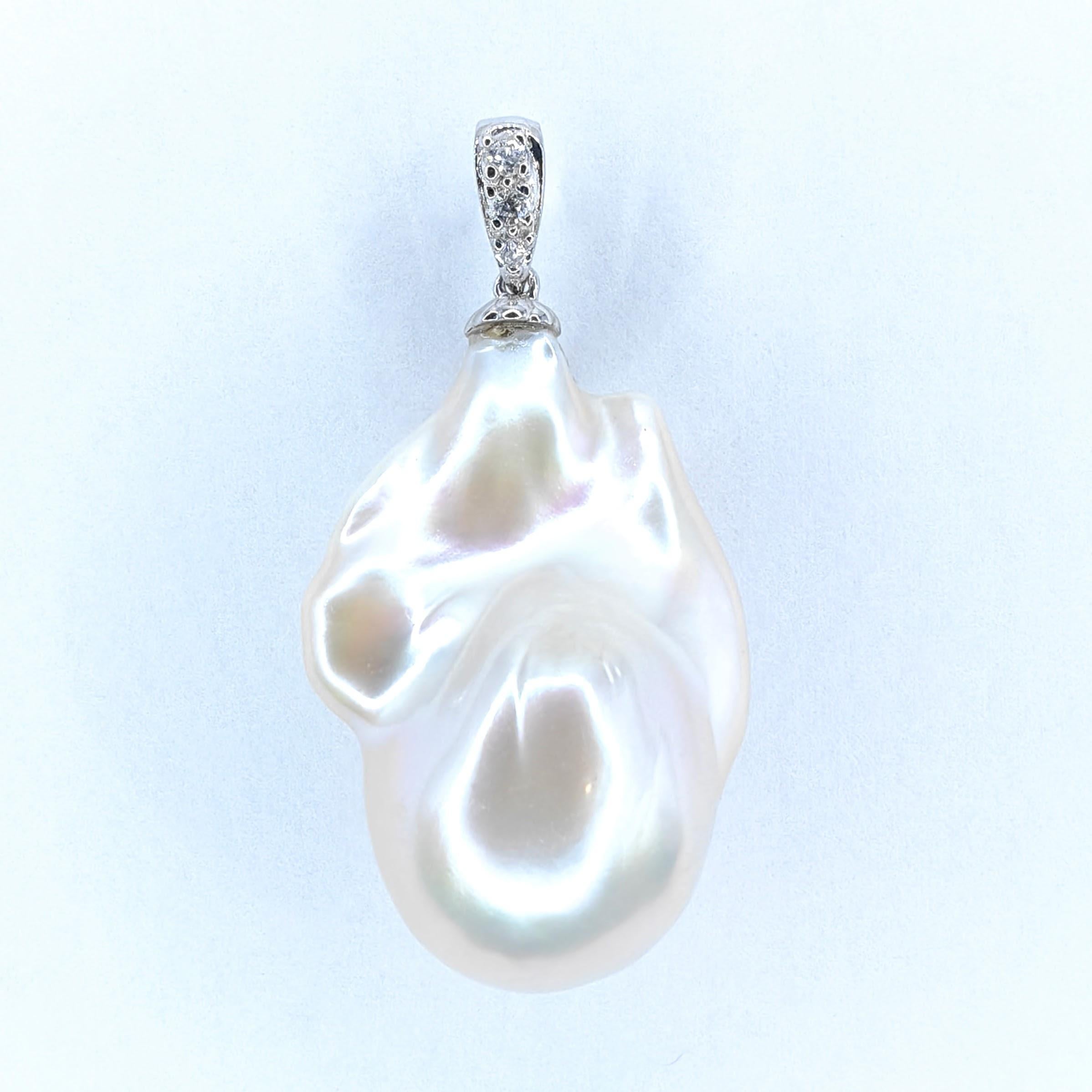 Introducing our meticulously crafted 30.67ct Iridescent Large Baroque Pearl Diamond Pendant Necklace in 18K White Gold. This remarkable piece of jewelry showcases the captivating allure and exquisite craftsmanship that make it truly exceptional.

At