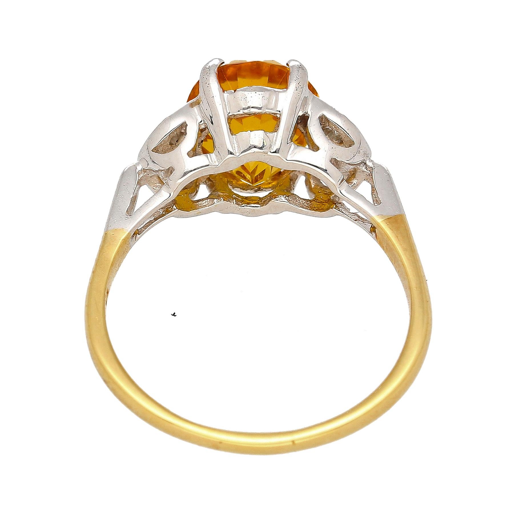 3.06 carat natural yellow sapphire and diamond ring. Set in a stunning 2-tone mounting of platinum and 14k yellow gold. The center stone explodes with brilliance and a vivid, rich yellow color saturation. Oval brilliant cut for maximum length and