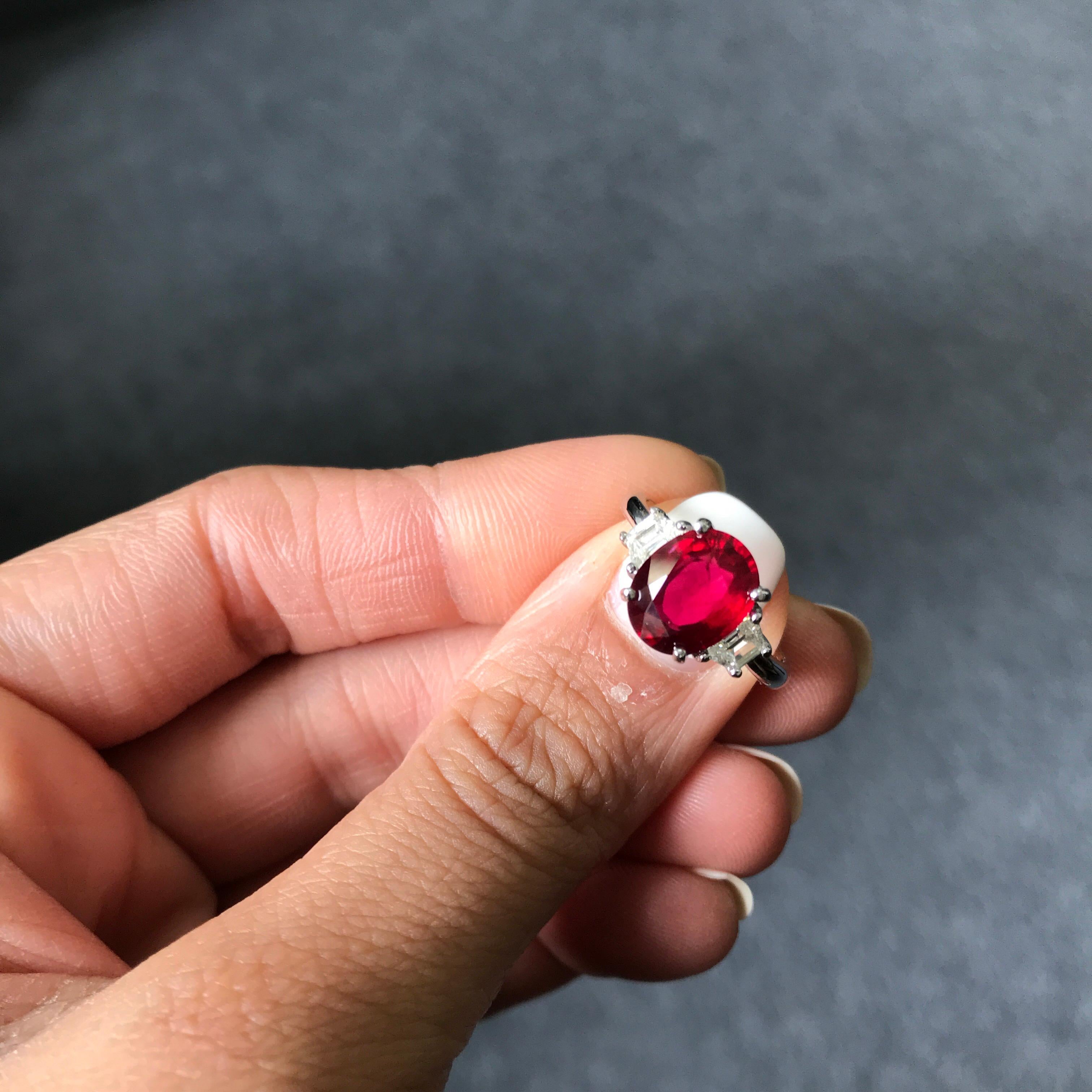 A beautiful three stone, engagement ring, with a 3.07 carat top quality and great colour oval cut Mozambique Ruby centre stone. 2 half-moon 0.40 carat side stones (total) Diamonds are set next to the centre stone, all set in 18K White Gold.