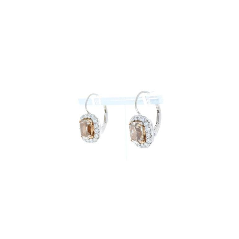 These eye-catching drop earrings are sure to get you noticed. Enduring and elegant, these fashionable earrings feature 3.07 carat total beautiful perfectly matched, natural cushion cut fancy cognac diamonds in the center, surrounded by sparkling