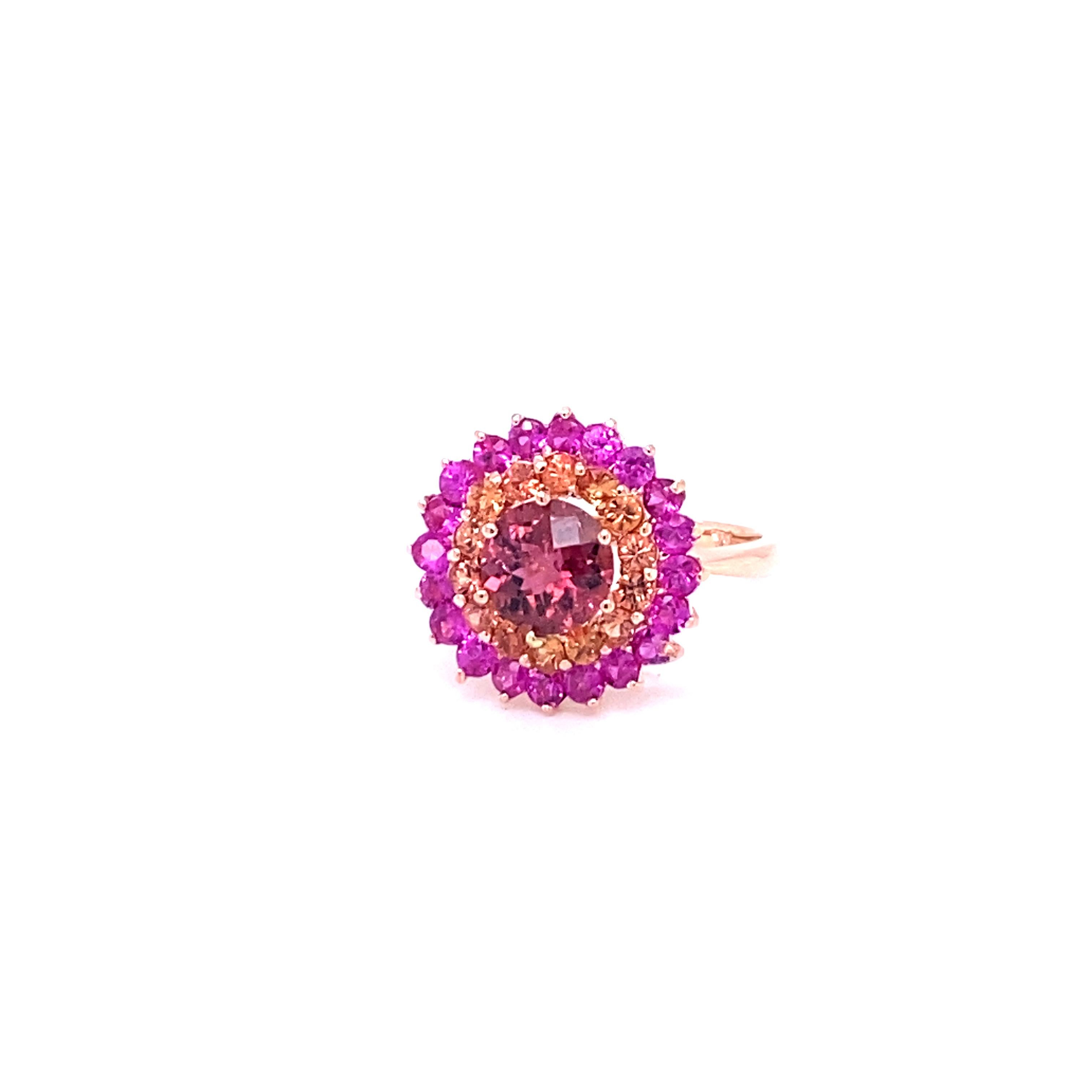 This Ring has a Round Cut Tourmaline that weighs 1.38 Carats and is surrounded by 24 Multi Sapphires that weigh 1.69 Carats. The Total Carat weight of this Ring is 3.07 Carats. 
This Ring is casted in 14K Rose Gold and weighs approximately 3.8