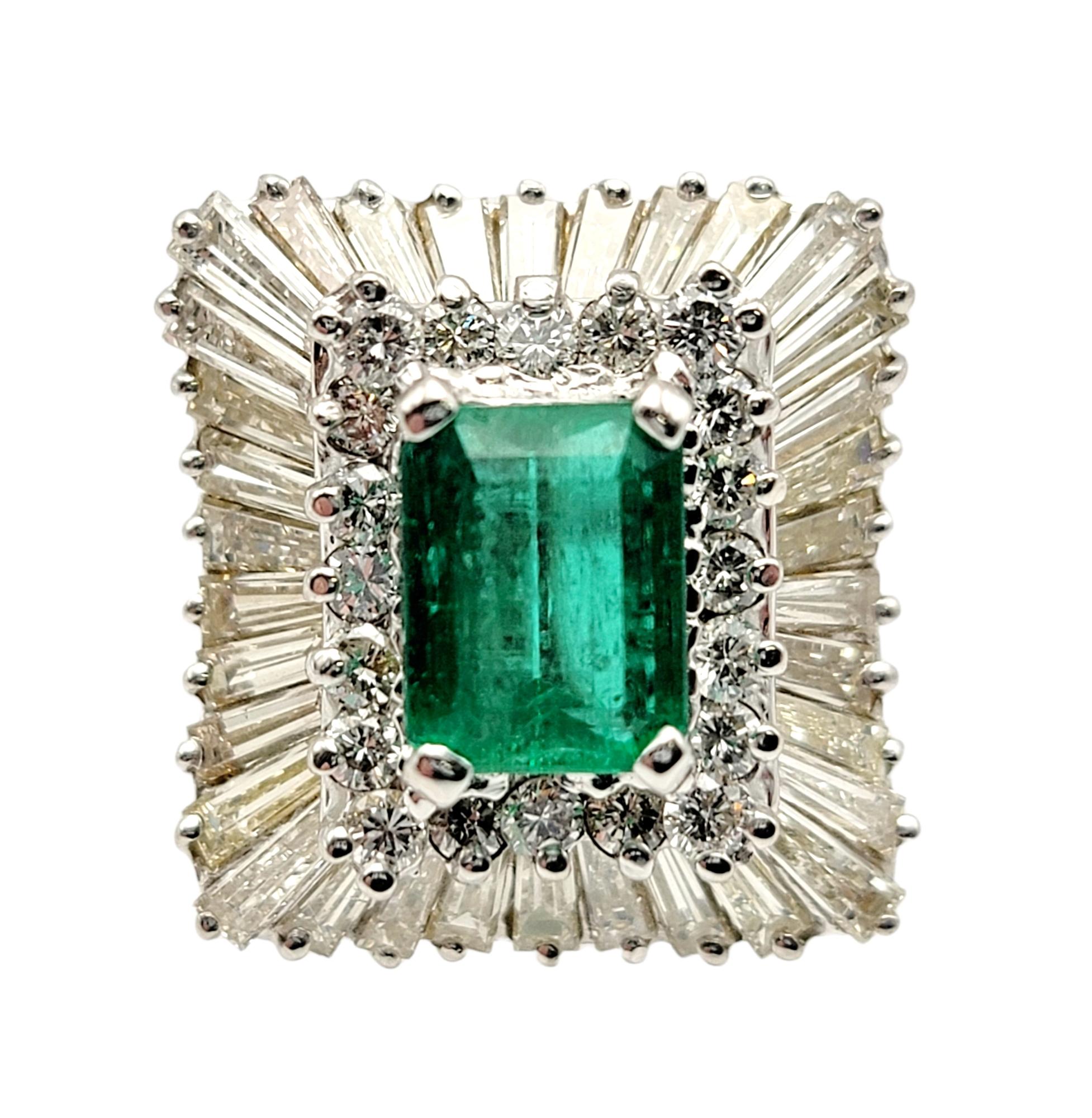 Ring size: 6

This stunning emerald and diamond cocktail ring is the absolute epitome of elegance. It features a single emerald cut natural emerald in a stunning bright green color, four prong set at the center of the piece. A halo of icy white