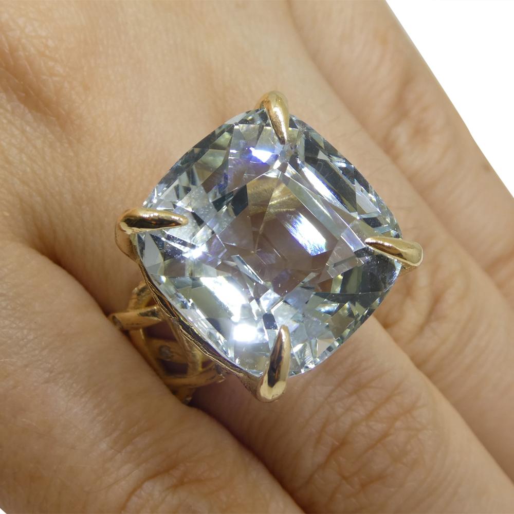 This is a stunning Aquamarine Ring is set with a sprinkle of diamonds in an 18k yellow  gold vine setting.   
    
 Gem Type: Aquamarine
Number of Stones: 1
Weight: 30.78 cts
Measurements: 18.64 x 17.78 x 14.12 mm
Shape: Cushion
Cutting Style Crown: