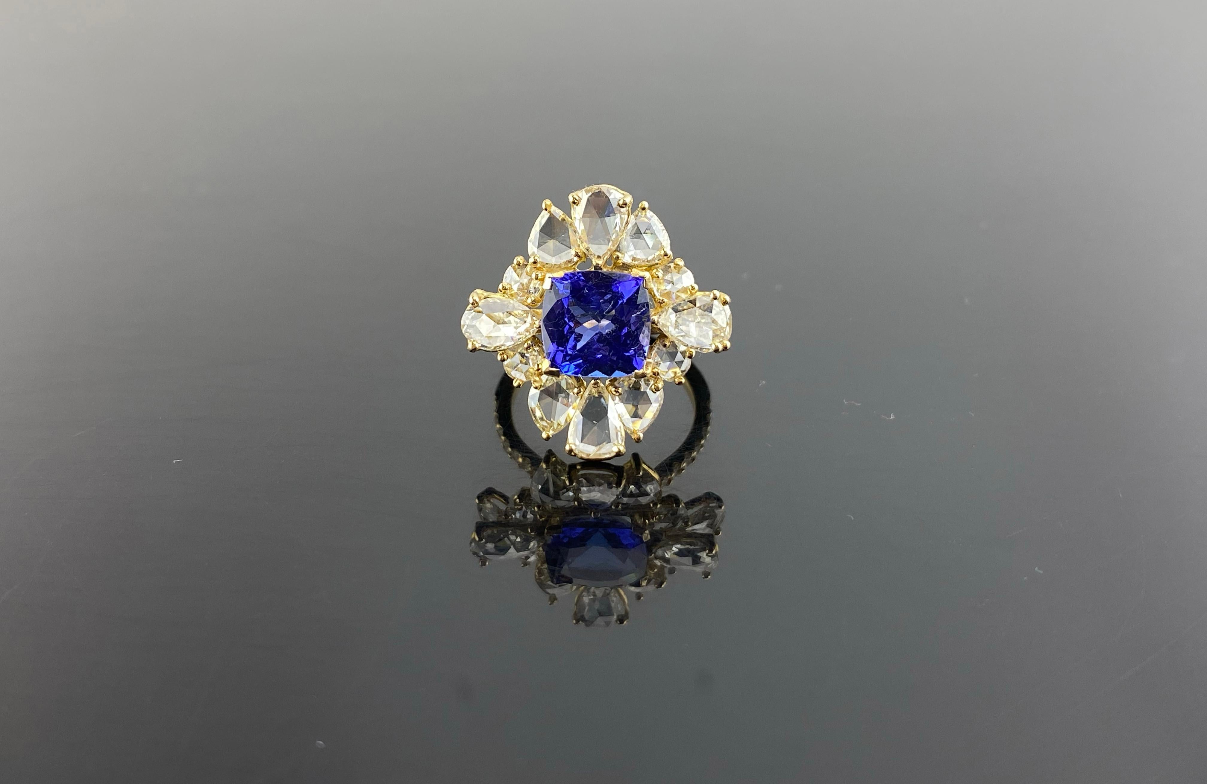 A beautiful, eye-catching 3.08 carat cushion shaped Tanzanite center stone adorned with 3.03 carat Diamonds all set in solid 18K Yellow Gold. The ring is sized at US7, can be resized. The center stone is transparent, with no inclusions and a