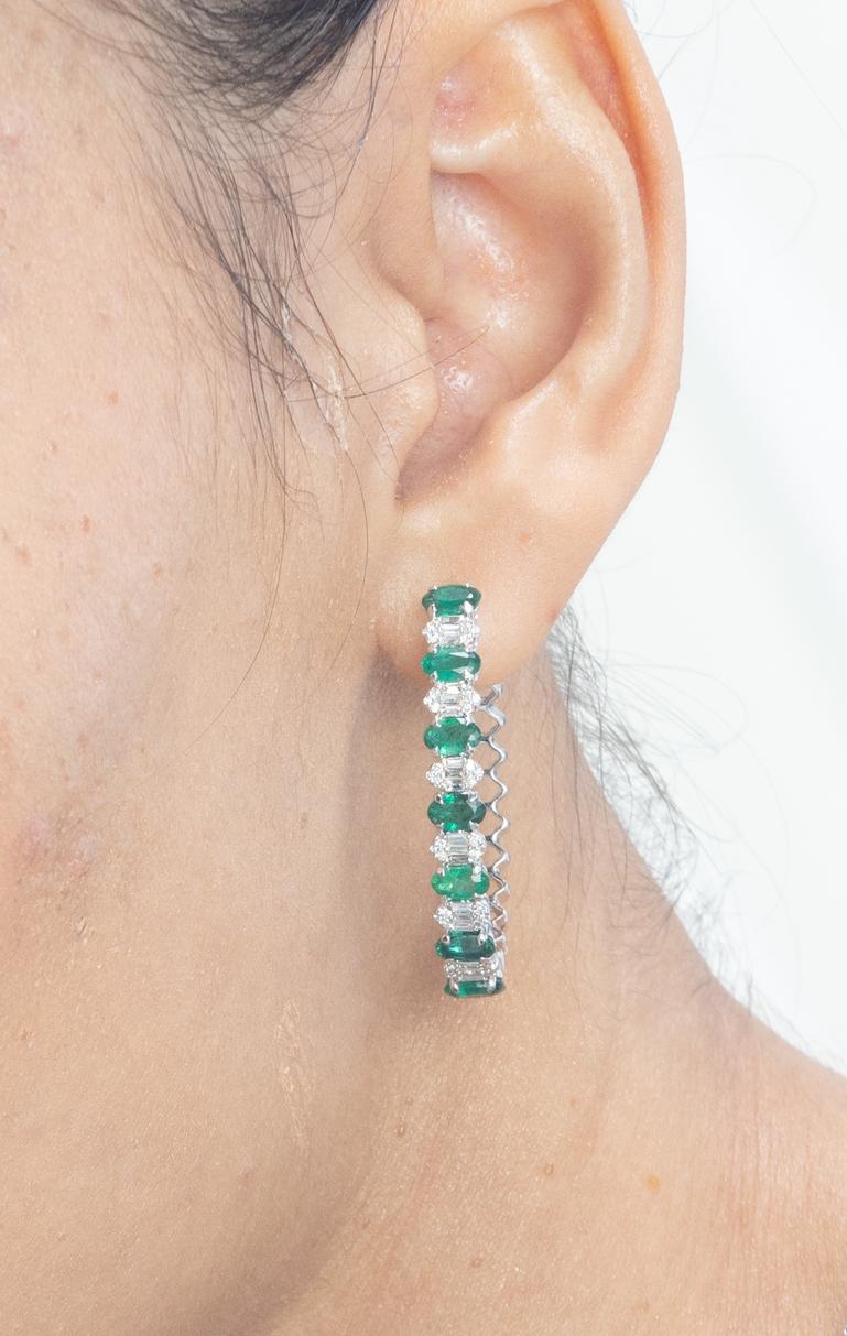 Natural Emerald and Diamond Hoop Earrings in 18K Gold to make a statement with your look. You shall need hoop earrings to make a statement with your look. These earrings create a sparkling, luxurious look featuring oval cut emerald and mixed cut
