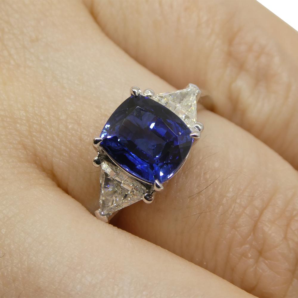 
Discover the allure of our Cushion-Cut Sapphire and Diamond Ring, a harmonious union of elegance and sophistication. At its center gleams a cushion-cut sapphire, weighing 3.08 carats. This sapphire, boasting a very slightly violetish blue hue,
