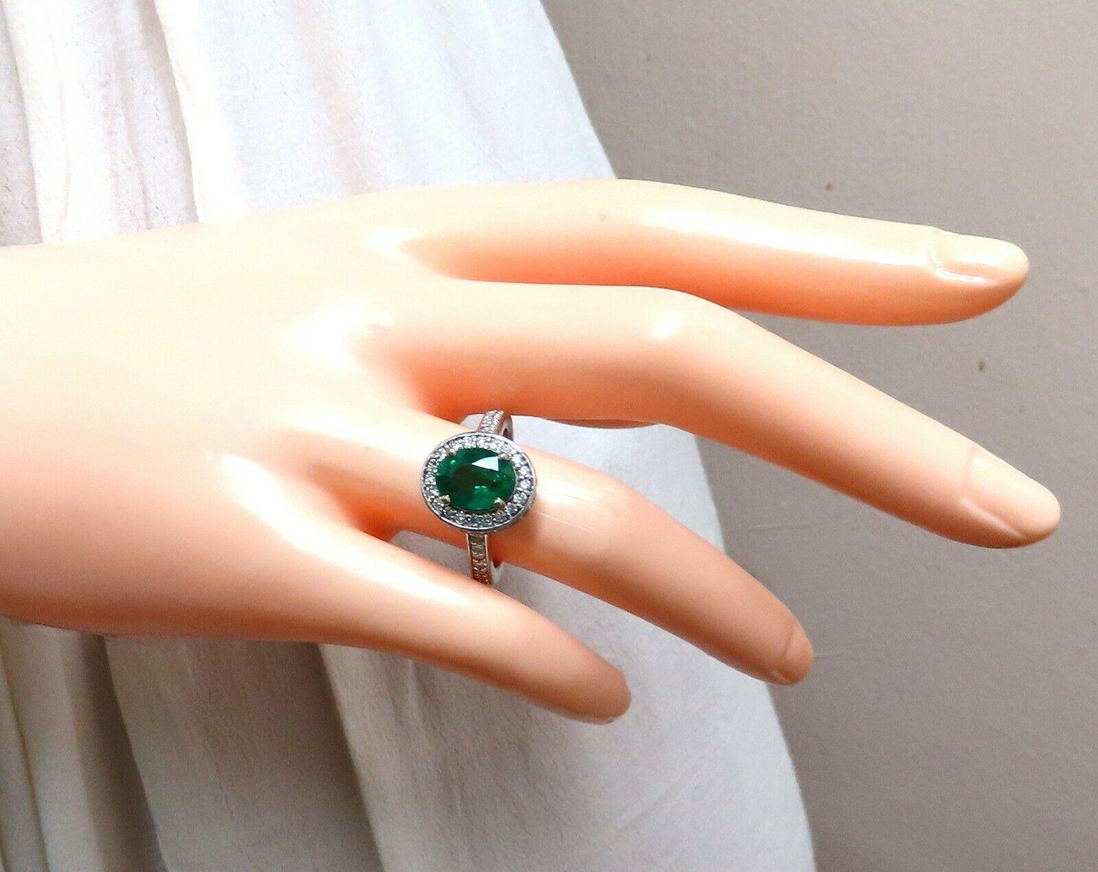 Halo Mod Deco Green.

2.03ct. Natural Oval cut, Emerald Ring

Emerald: 9.5 x 7.3mm 

Transparent & Vivid Green 

1.05ct. Diamonds.

Round & full cuts 

G-color Vs-2 clarity.  

14kt. white gold

6.2 grams

Ring Current size: 7

Depth of ring: