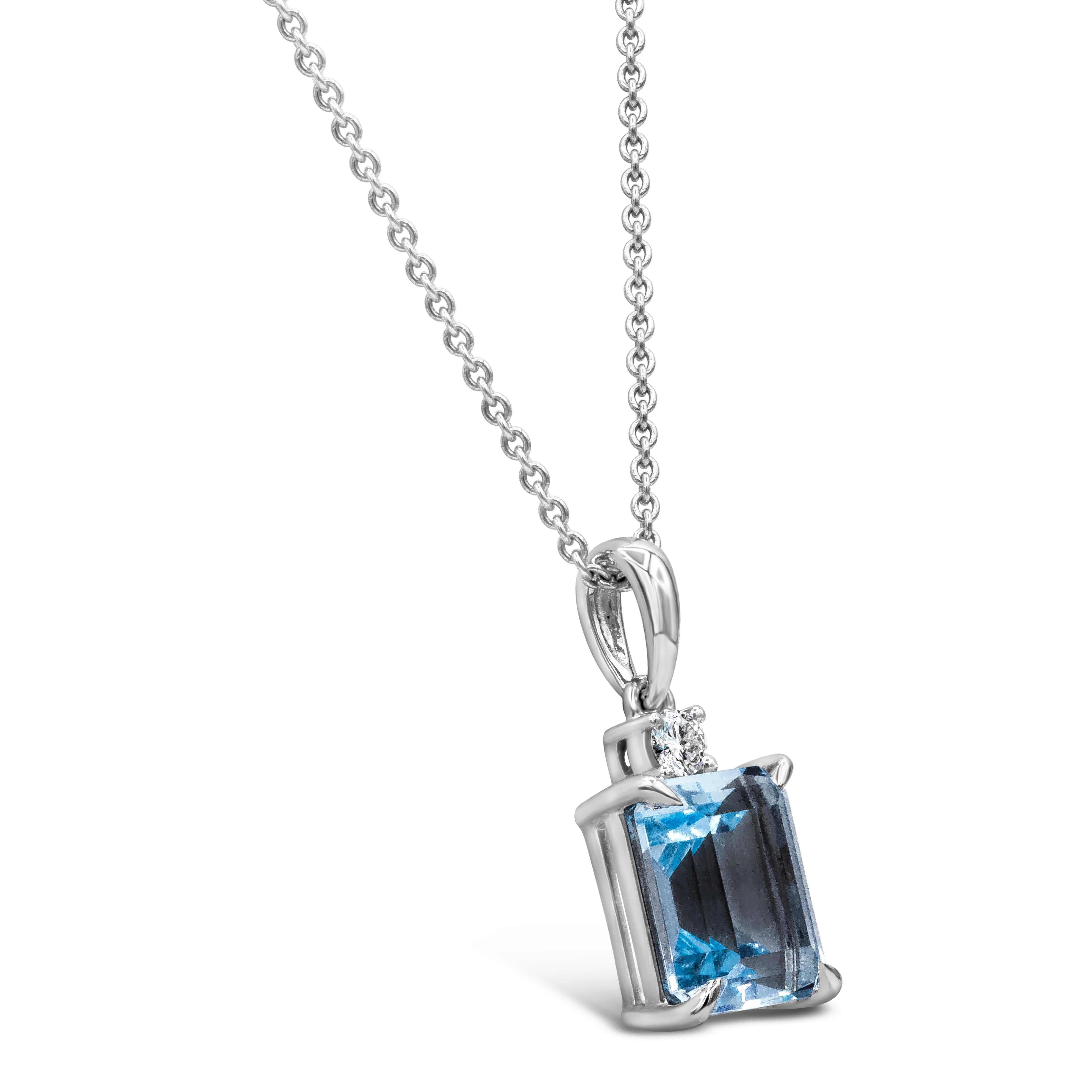 A simple solitaire pendant necklace showcasing a 3.09 carat emerald cut blue topaz, accented by a single round diamond. Made in 18 karat white gold. Suspended on a 16 inch chain (adjustable upon request).

