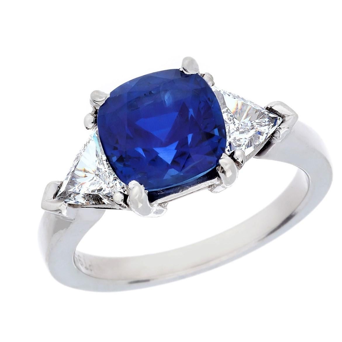 Platinum Burma Blue Sapphire and Diamomnd 3-Stone Ring, The sapphire is a cushion shape with 2-side trillion cut diamonds to total 0.69 carats.  The hand made mounting is stamped 950 Pt.
The amazing Royal Blue color is amazing. 
Finger Size: 6.5