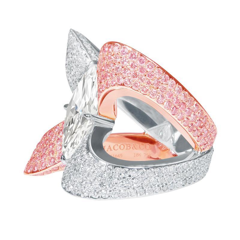 Estate Jacob & Co. 3.09ct Marquise Diamond Ring. This statement ring has a resplendent 3.09ct marquise cut center stone set in a 4 prong setting.  A bold criss-cross design combines pavè fancy pink diamonds set in 18kt rose gold and pavè white