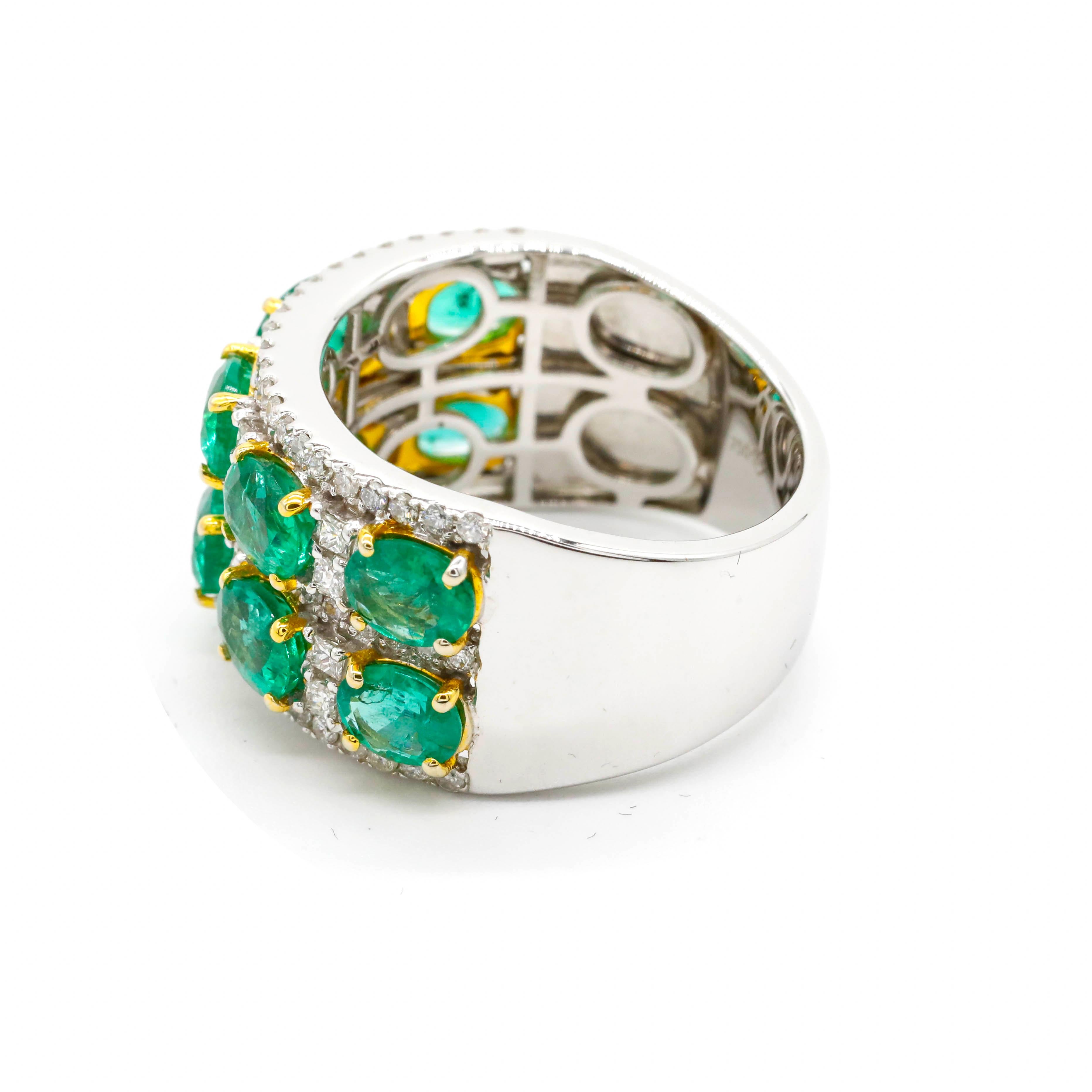 3.09 Carat Oval Cut Emerald and Round Diamond Band Ring in 18k Two-Tone Gold

Glamorous look. The set of oval-shaped emeralds are set in three-stone horizontal rows in a prong setting. Diamonds are layered around the emeralds, creating a wide unique