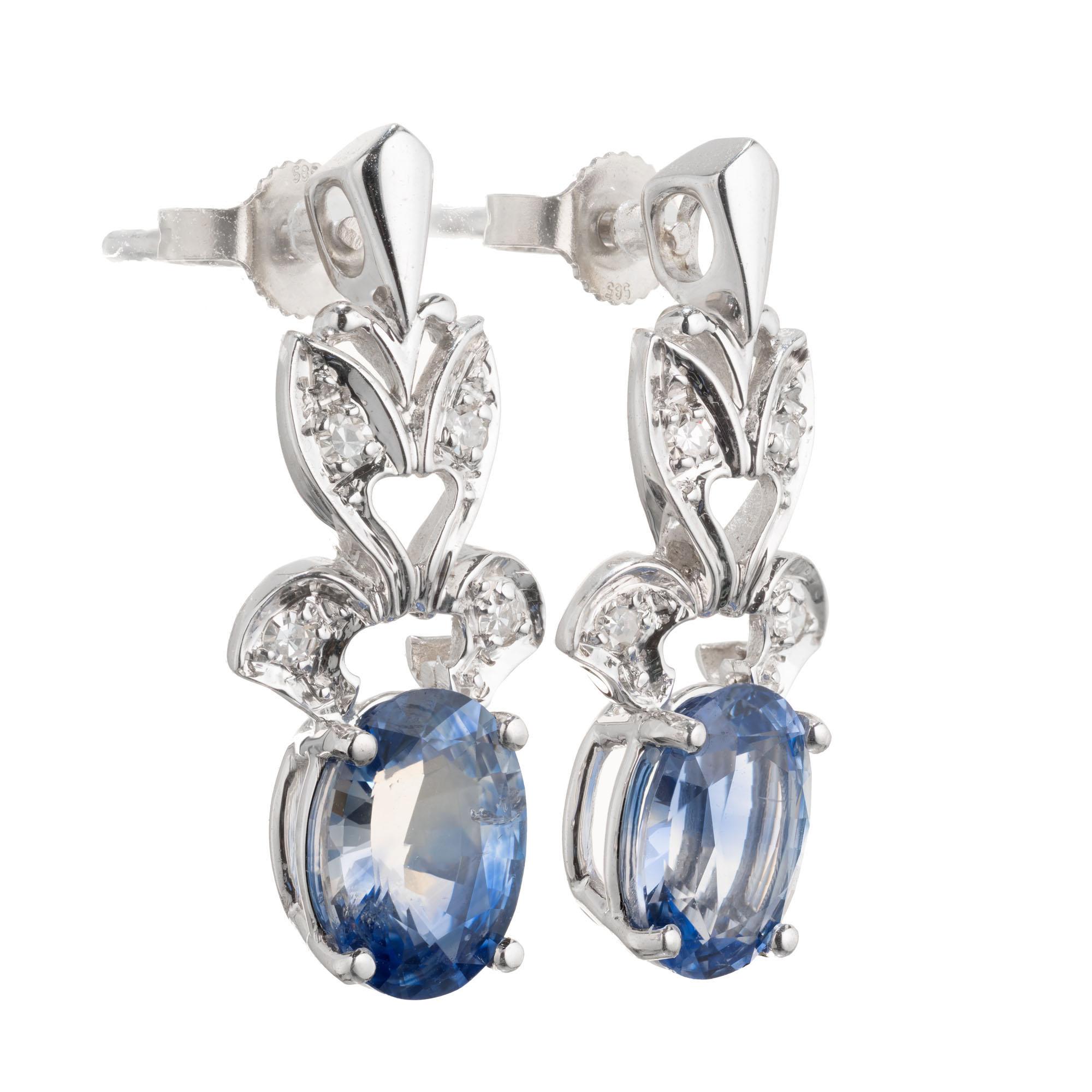 Handmade circa 1950's Oval Sapphire and Diamond Dangle Earrings. . Simple heat only. AGL certified. 14k White gold. 

1 oval bi-color blue and colorless Sapphire, approx. total weight 1.54cts, VS2 - SI1, 8.33 x 6.12 x 3.71mm, natural color and