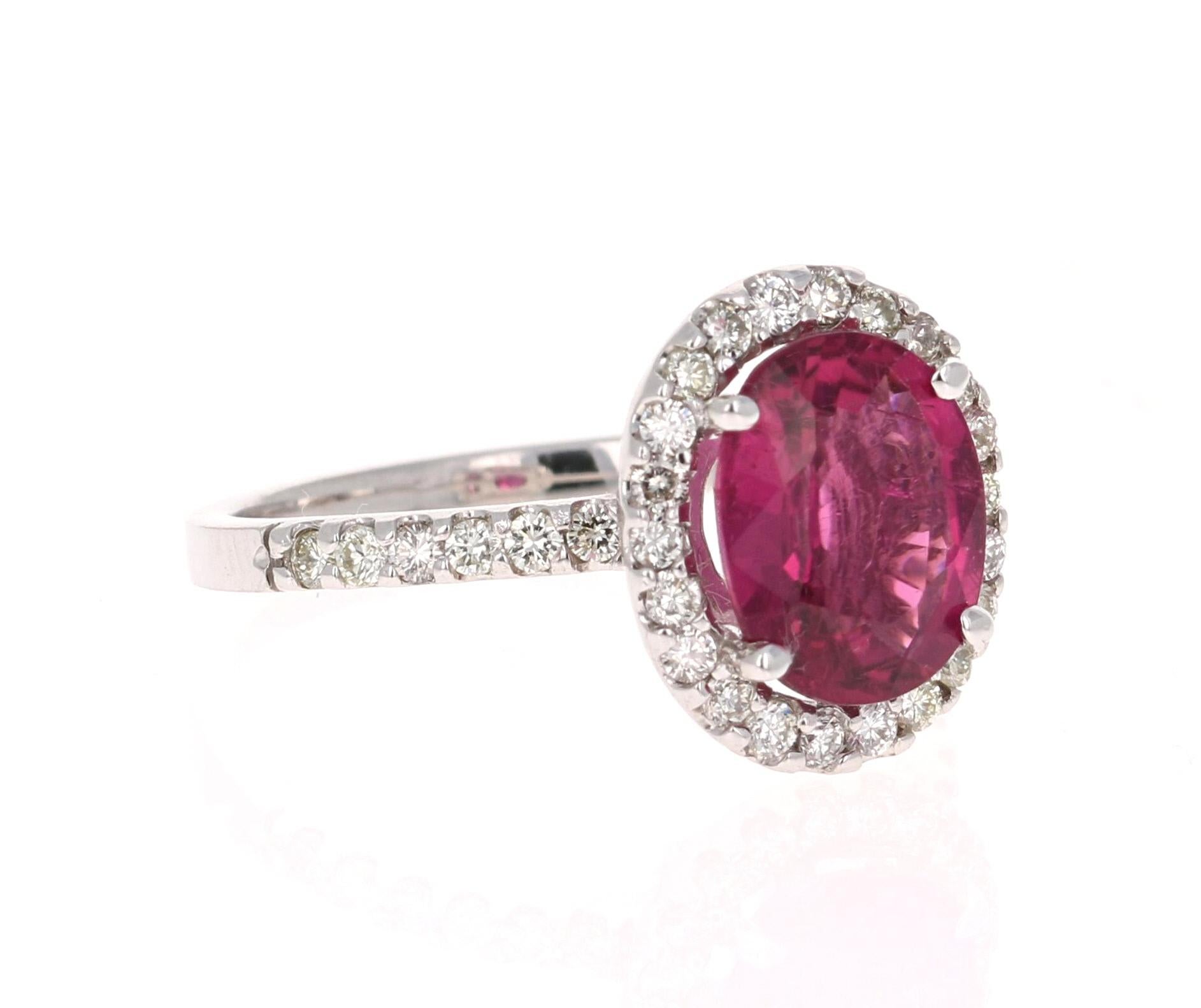 
This ring has an Oval Cut Pink Tourmaline that weighs 2.52 Carats. Floating around the tourmaline are 34 Round Cut Diamonds weighing 0.57 Carats. The total carat weight of the ring is 3.09 Carats. 

The ring is made in 14 Karat White Gold and