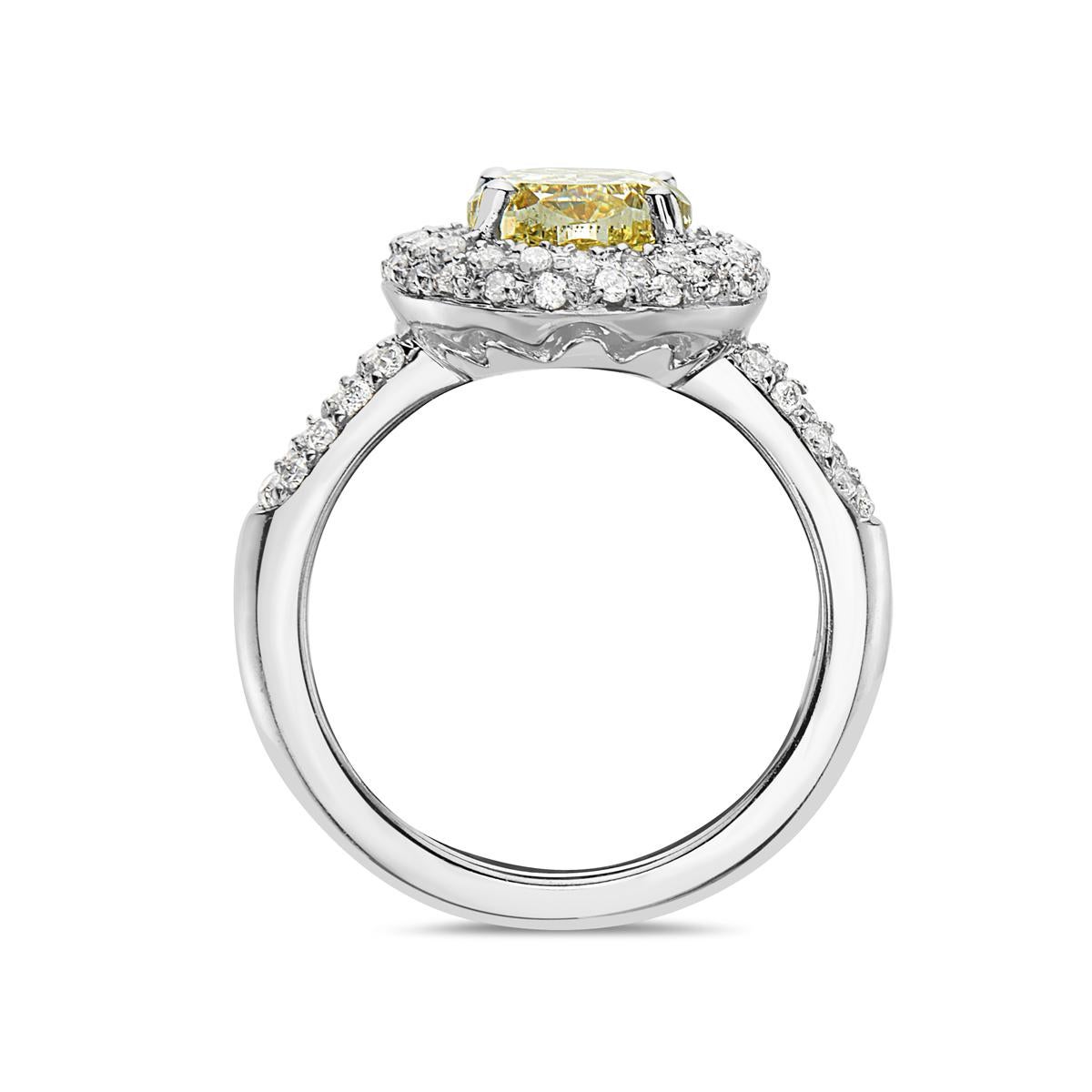 This engagement ring features a 3.09 carat VVS yellow diamond with a G-H VS diamond halo setting weighing 1.10 carats. 7.8 grams total weight. Made in Italy. Size 6 3/4.

Viewings available in our NYC showroom by appointment.