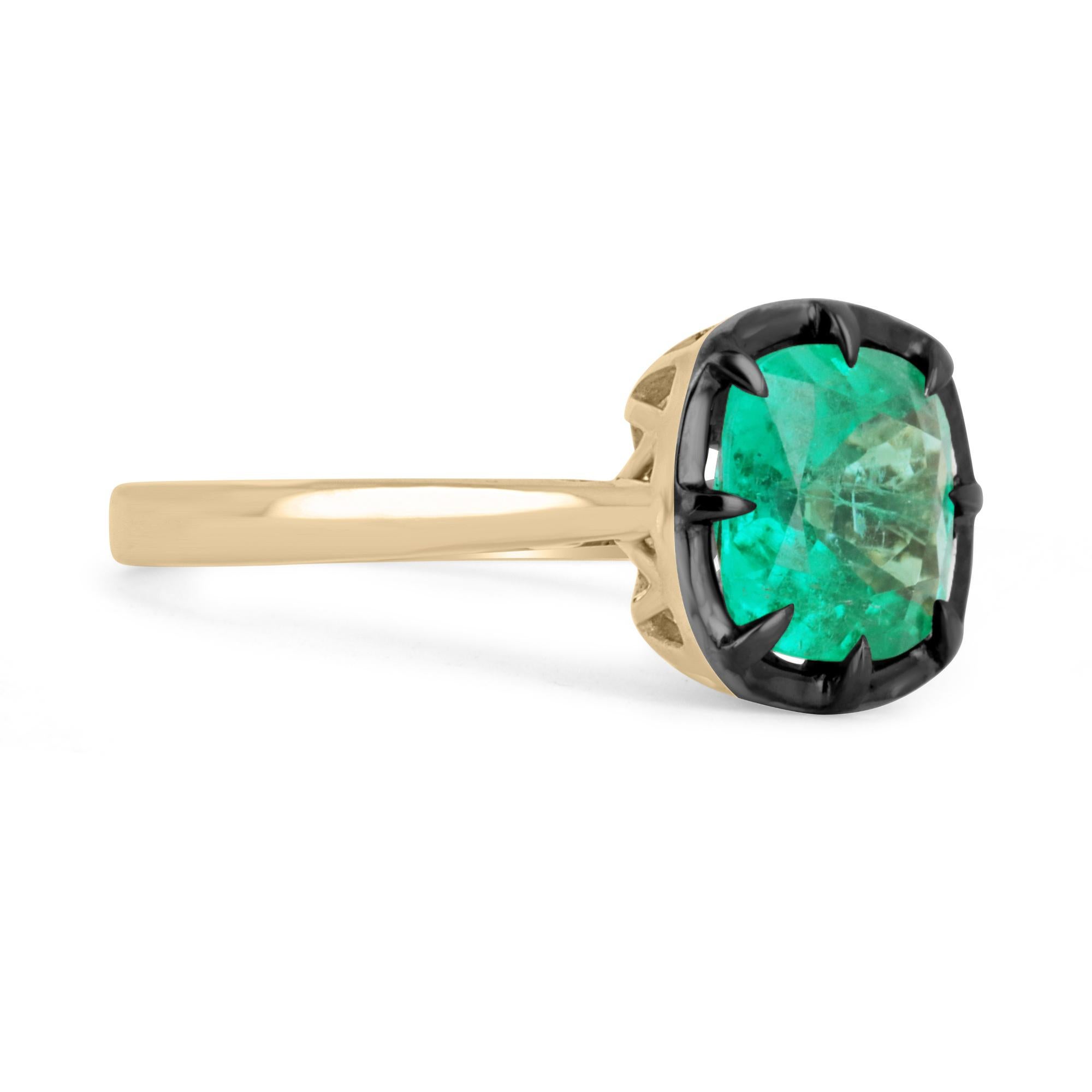 Displayed is a Colombian emerald Georgian-styled solitaire Cushion-cut engagement or right-hand ring in 14K yellow gold. This gorgeous solitaire ring carries a full 3.0-carat emerald in a semi-bezel multiprong setting. Black rhodium highlights the