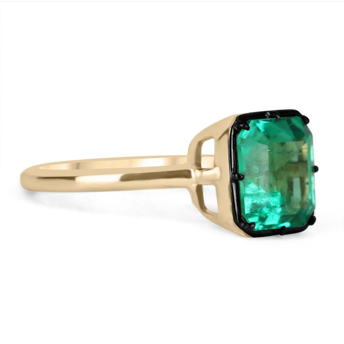 Displayed is a Colombian emerald Georgian styled solitaire Asscher-cut engagement or right-hand ring in 18K yellow gold. This gorgeous solitaire ring carries an exceptional, GLOWING 3.0-carat emerald in a prong setting. Black rhodium highlights the