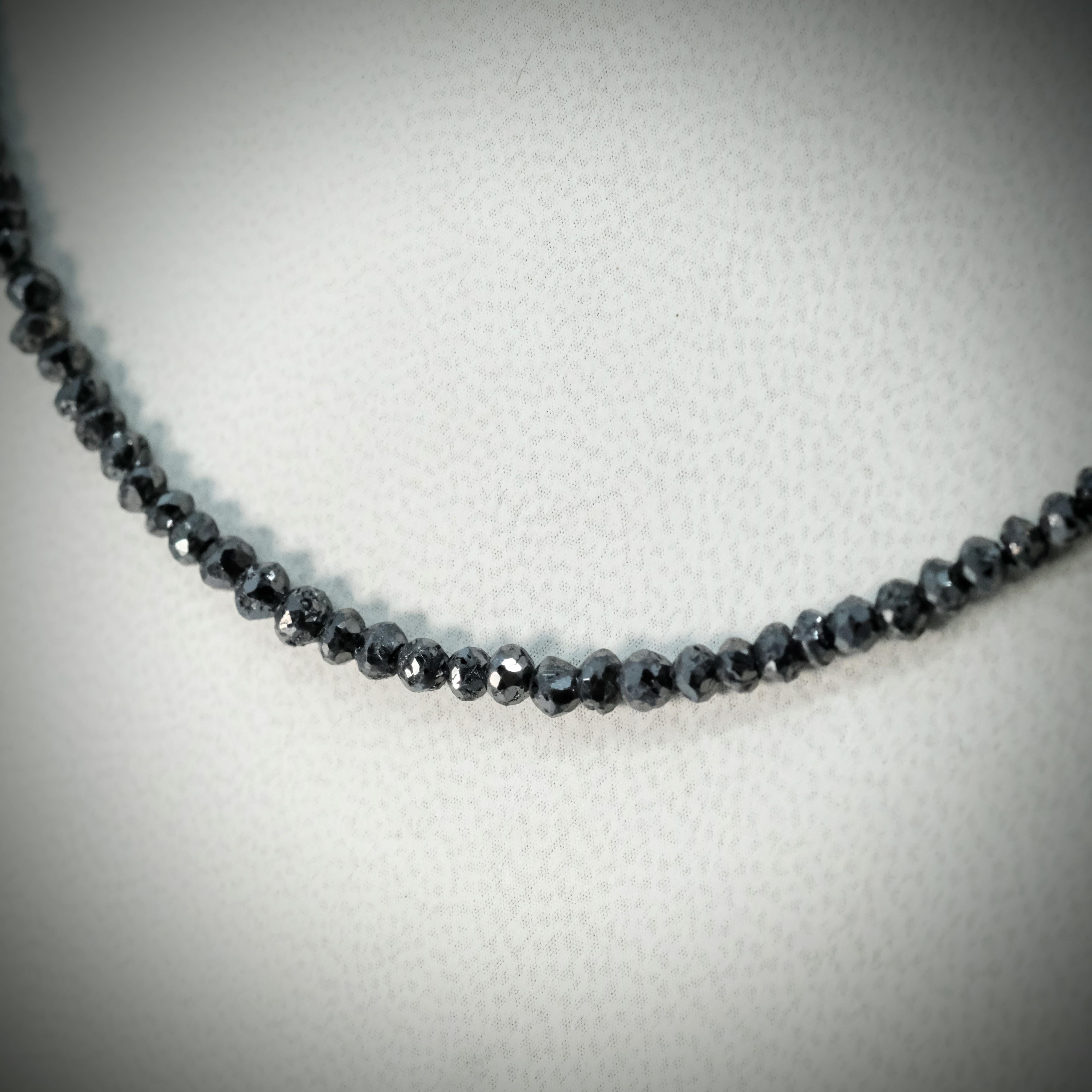 A BUNDA black diamond 'Karst' necklace, strung with faceted black diamond beads on wire thread with a clasp in 18 carat yellow gold.

Weight of black diamonds: 30.00ct