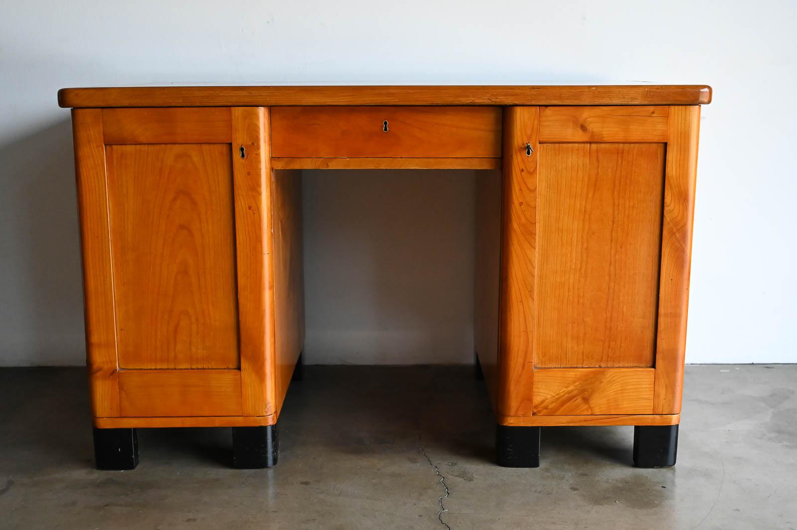30's Art Deco Pine Desk in the style of Jean Pascaud. Handmade heavy solid pine, this beautiful desk has the original key with locking doors and inner sliding drawers. Measures 49
