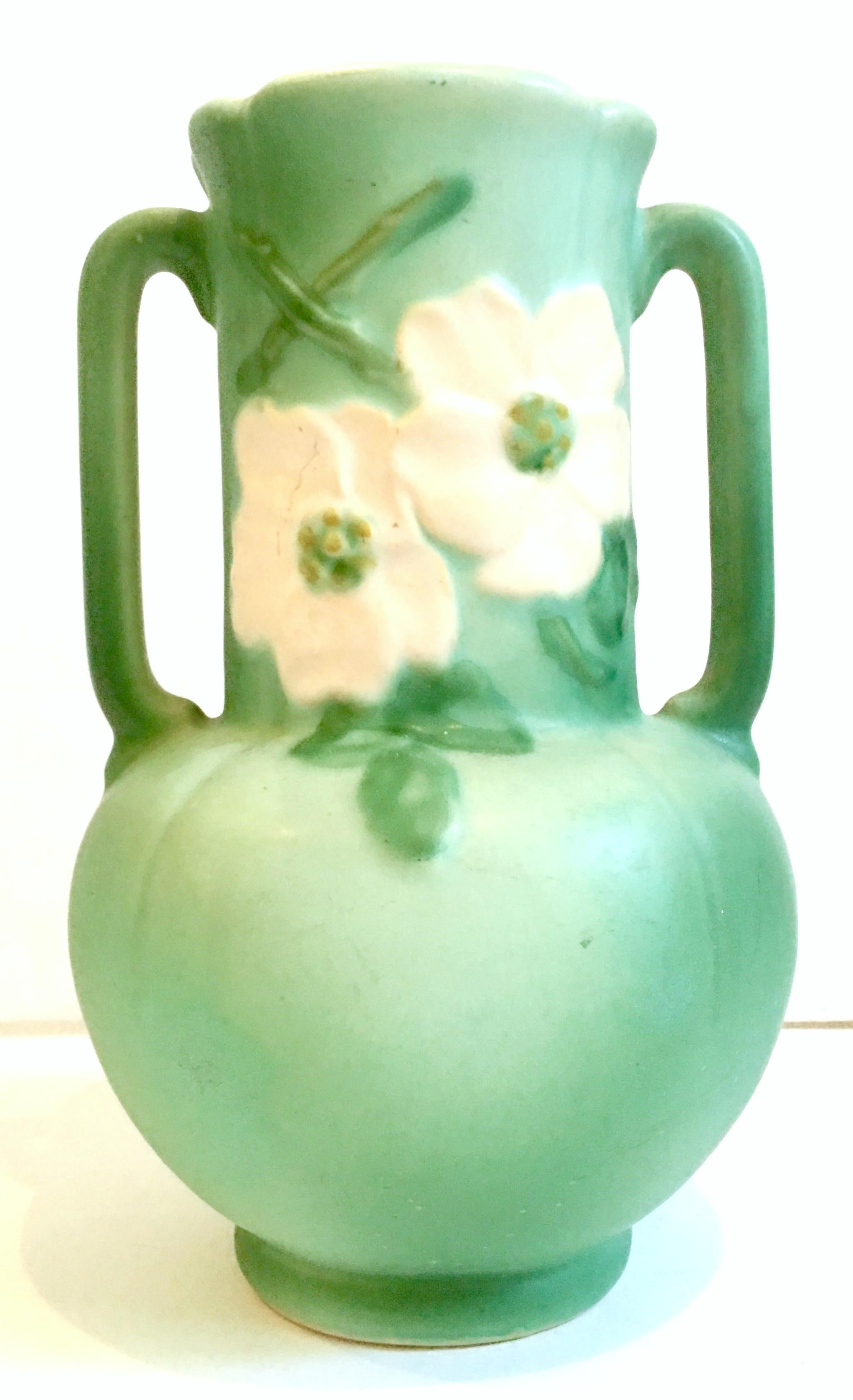 1930'S Weller Pottery matte sea green, two-handle vase with raised white floral and leaf motif.
Inscribed, signed Weller on the underside with the letter 