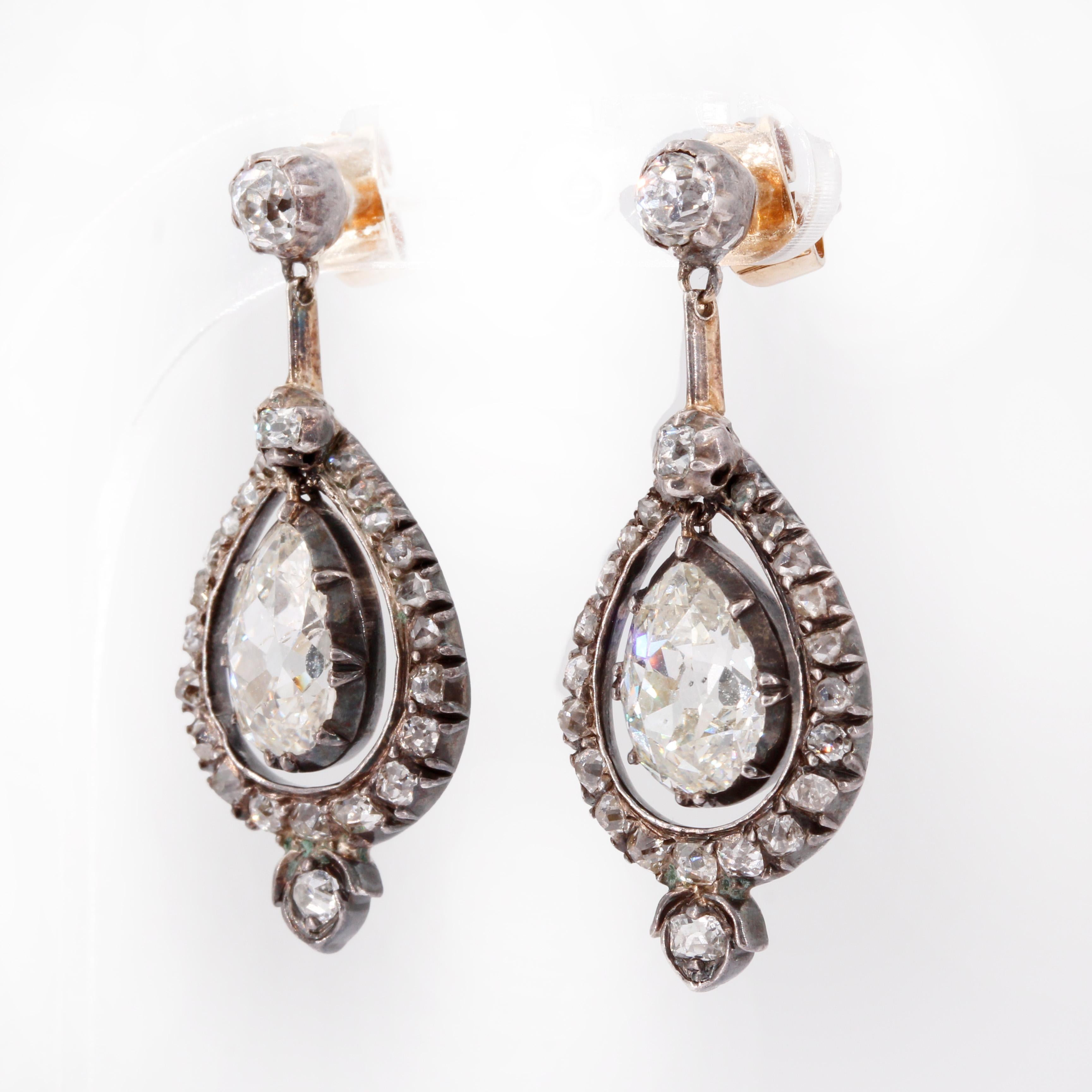 Antique white gold and diamond earrings. 
Approx. 1ct. old cut diamonds and 3.1ct old pear shape diamonds