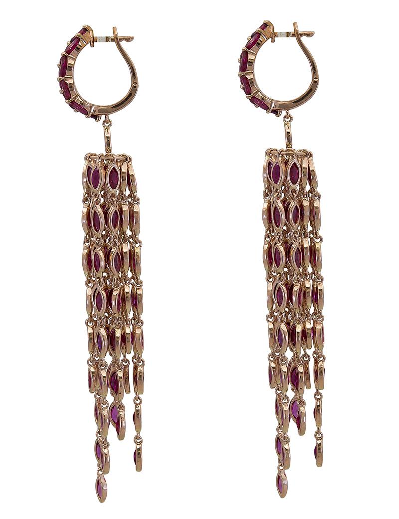 A unique and fashionable pair of earrings showcasing a rose gold hoop set with marquise cut rubies, accented with a fringe chandelier design of more rubies. Made in 18k yellow gold.
Rubies weigh approximately 31 carats total.
Dimensions: 3.69in (L)