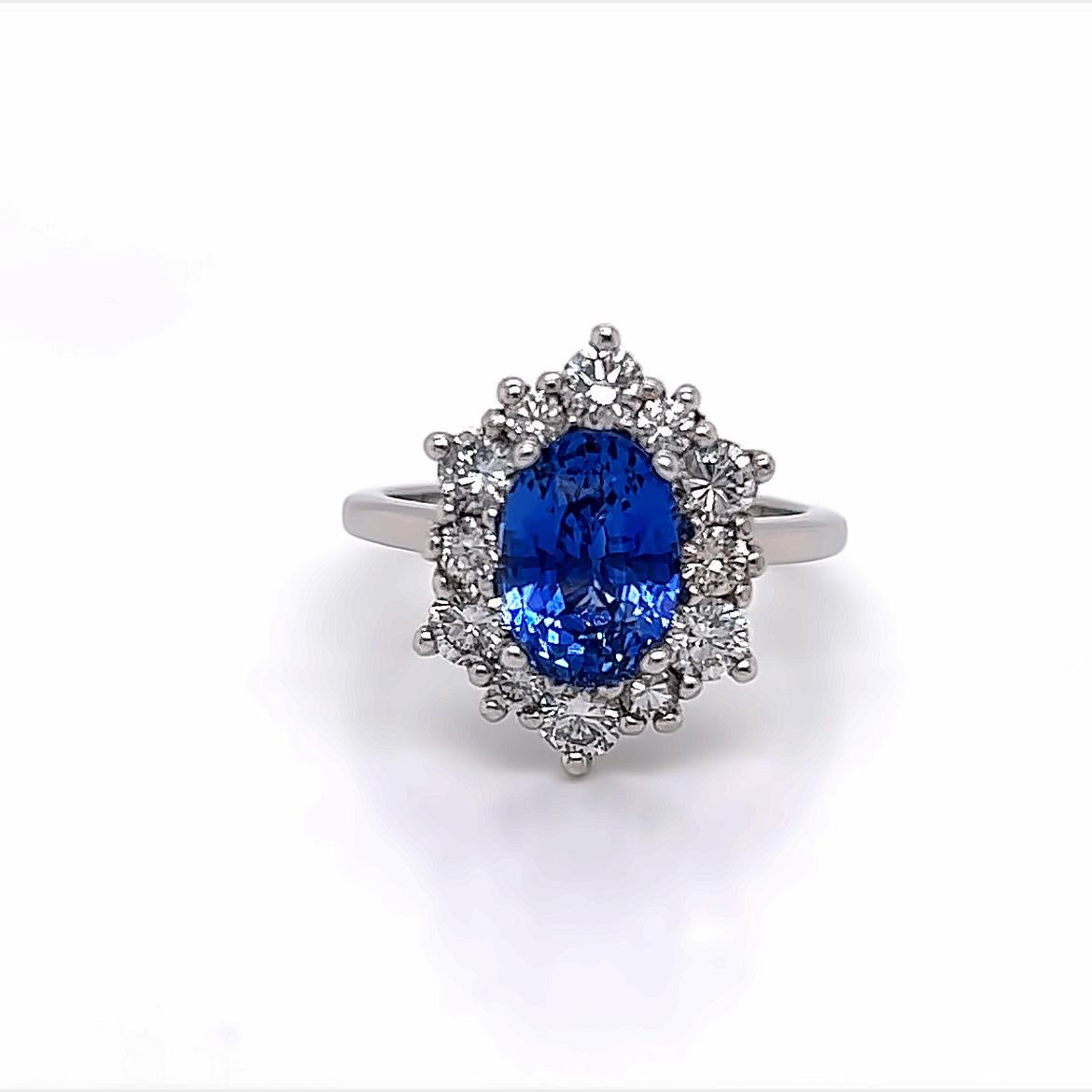 This spectacular ring features an oval cut 3.1 carat Blue Sapphire at its centre, surrounded by an iridescent arrangement of 12 glittering diamonds, all held together on a Platinum band.

The Blue Sapphire at the centre of this ring is a uniquely