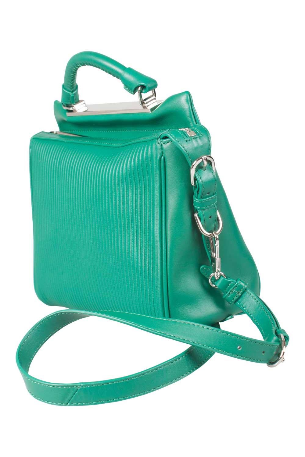 This top handle Ryder bag comes with a detachable shoulder strap and features an open compartment at the back. Designed by 3.1 Philip Lim, the green leather bag has a spacious canvas interior that is secured by a silver-tone zipper. Carry the