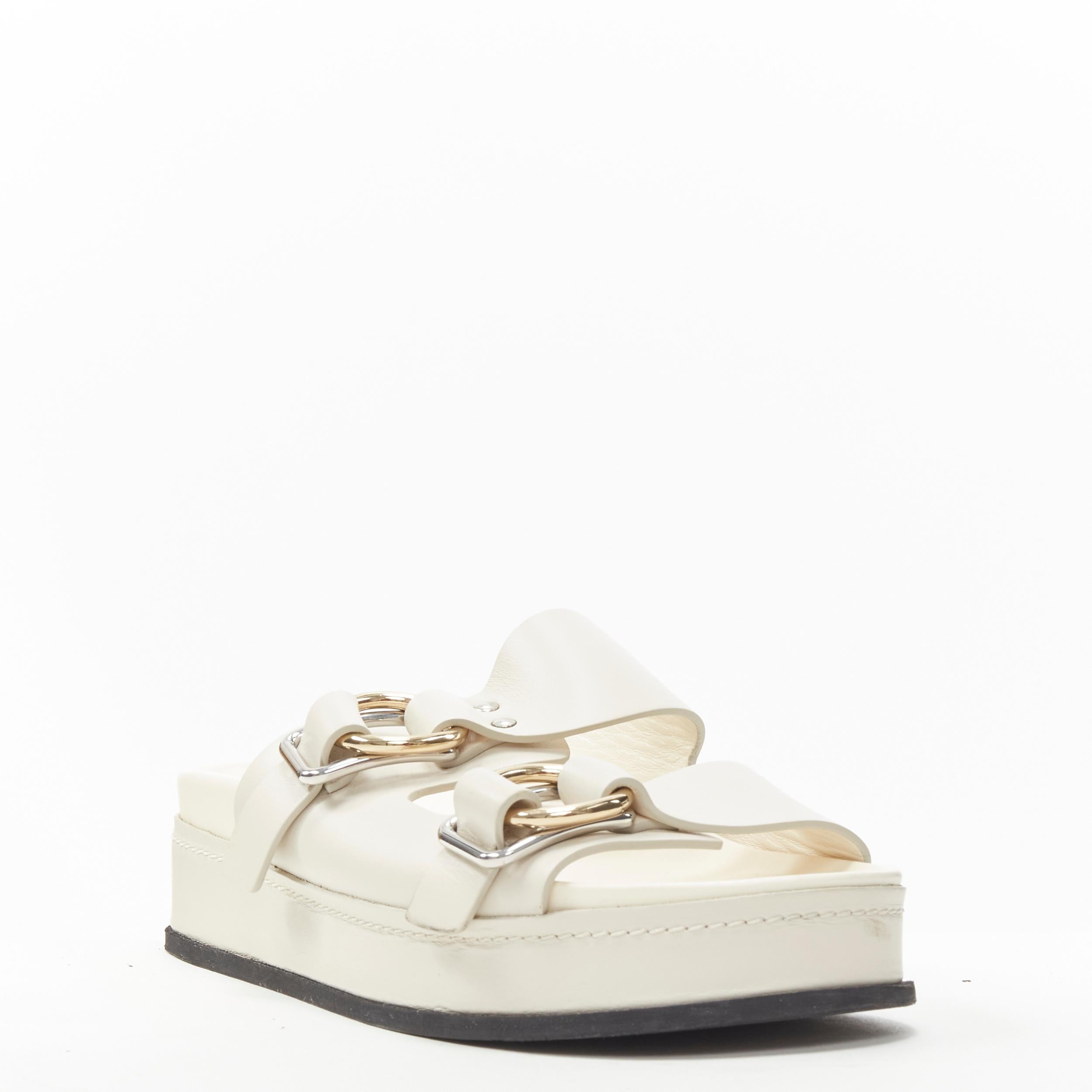 3.1 PHILLIP LIM cream white leather mixed metal buckle platform sandals EU38 US8 
Reference: LNKO/A01895 
Brand: 3.1 Phillip Lim 
Designer: Phillip Lim 
Material: Leather 
Color: White 
Pattern: Solid 
Extra Detail: Mixed metal shaped buckle. 
Made
