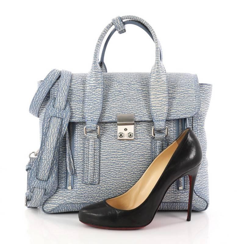 This authentic 3.1 Phillip Lim Pashli Satchel Leather Medium is a practical bag with a stylish edge made for on-the-go moments. Crafted from light blue leather, this chic satchel features dual top handles, expandable zip sides, top flap push-lock