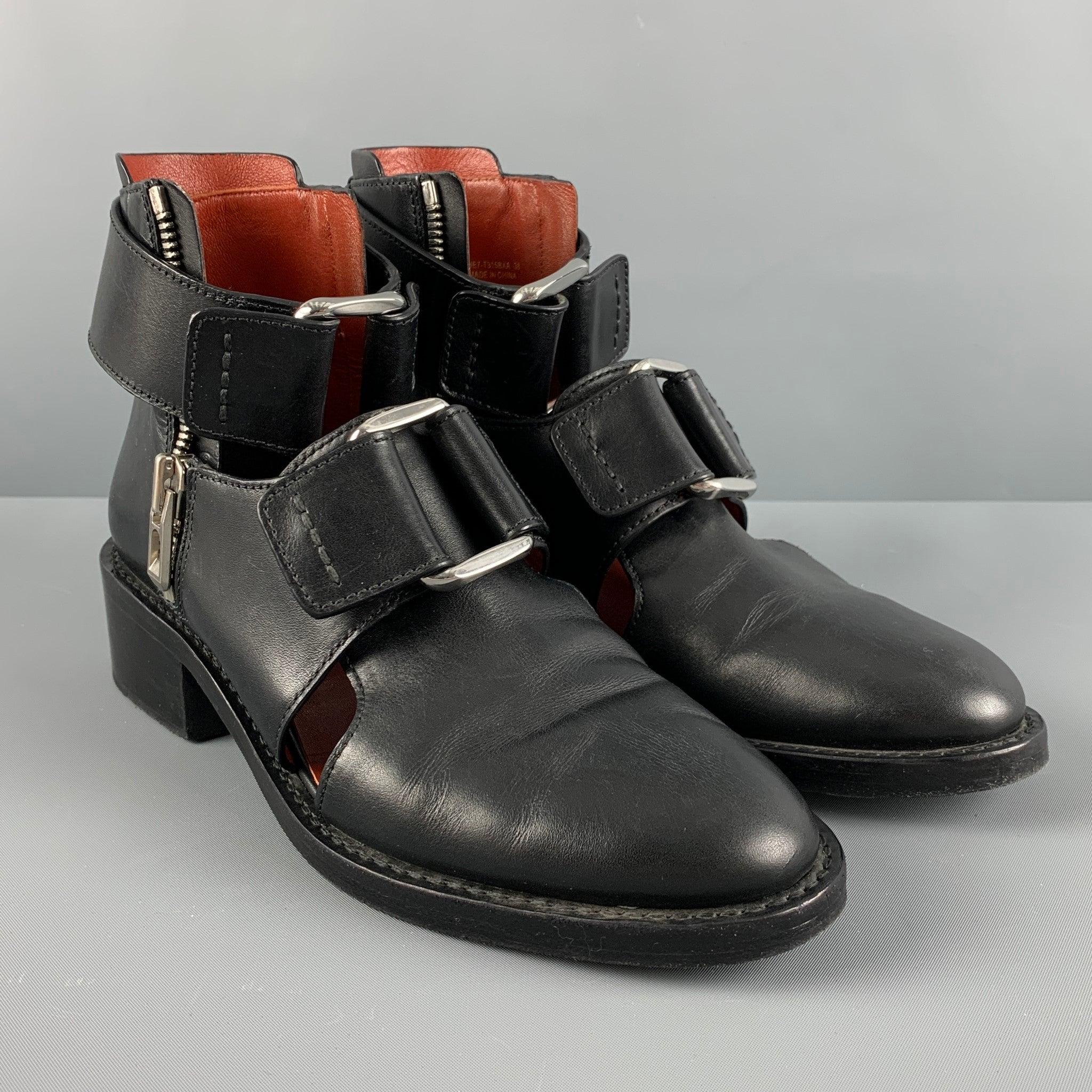 3.1 PHILLIP LIM ADDIS ankle boots comes in a black leather with cut out details featuring a silver tone buckles, slip on, and a wooden sole. Comes with Box.Very Good Pre-Owned Condition. 

Marked:   SHE7- T3158XA 38 

Measurements: 
  Length: 10.75