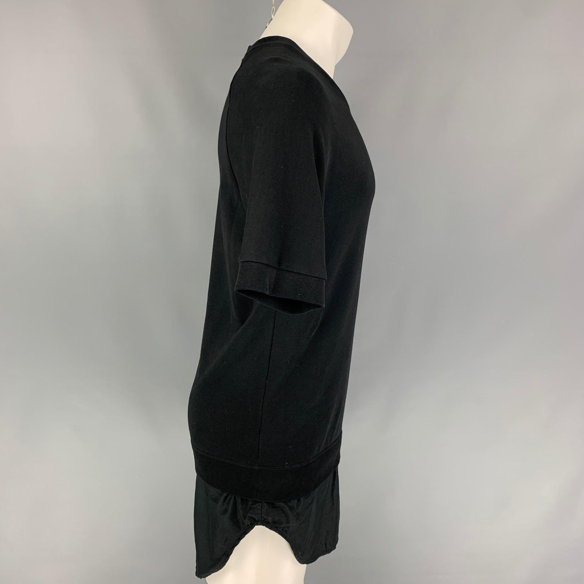 3.1 PHILLIP LIM pullover comes in a black cotton featuring a shirt panel, short sleeves, and a crew-neck.
Very Good
Pre-Owned Condition. 

Marked:   S 

Measurements: 
 
Shoulder: 16.5 inches  Chest: 40 inches  Sleeve: 11 inches  Length: 35 inches 
