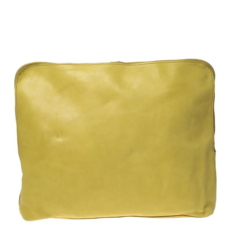 This clutch by 3.1 Phillip Lim is a creation that is not only stylish but also exceptionally well-made. Meticulously crafted from yellow leather, it flaunts dual zippers that lead to a well-sized interior. High on style and design, this clutch