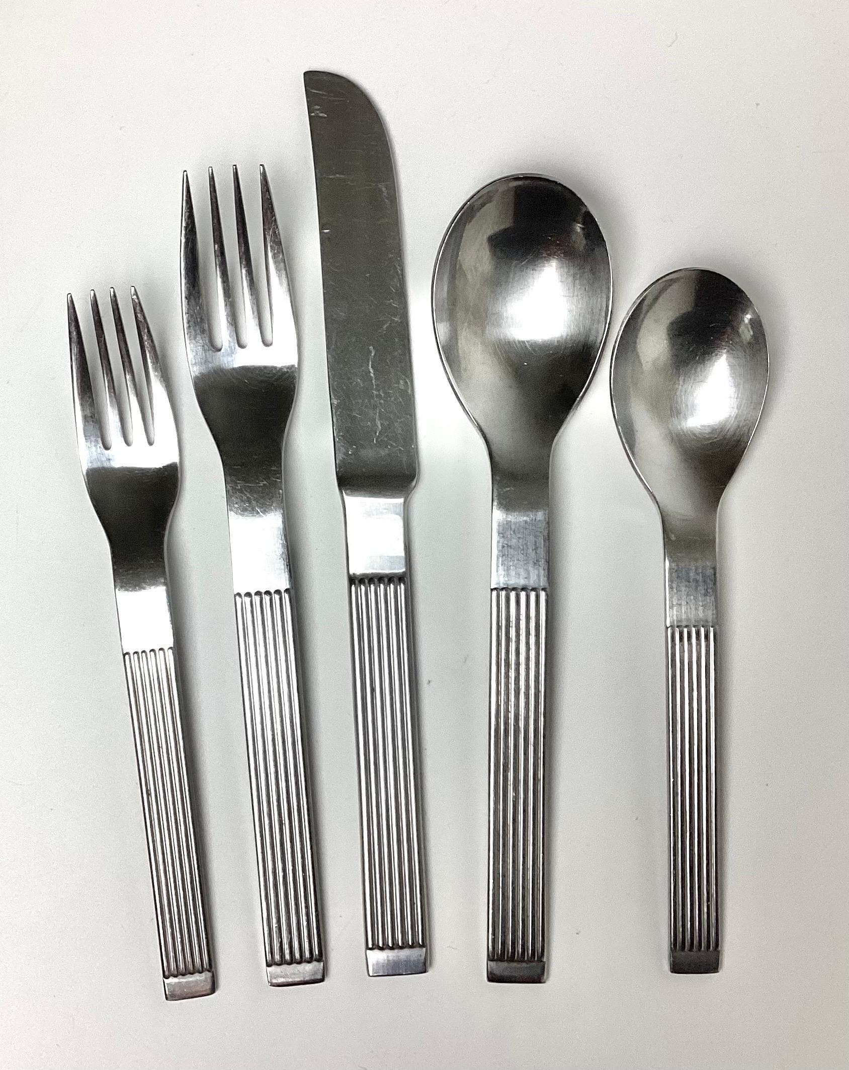 31 Piece Modern THEBE by Dansk stainless steel flatware set. Some pieces are marked Japan others Korea. Age appropriate wear. 6 Dinner Knifes, 7 dinner forces, 5 salad forks, 6 larger or soup spoons, and 7 tea spoons.