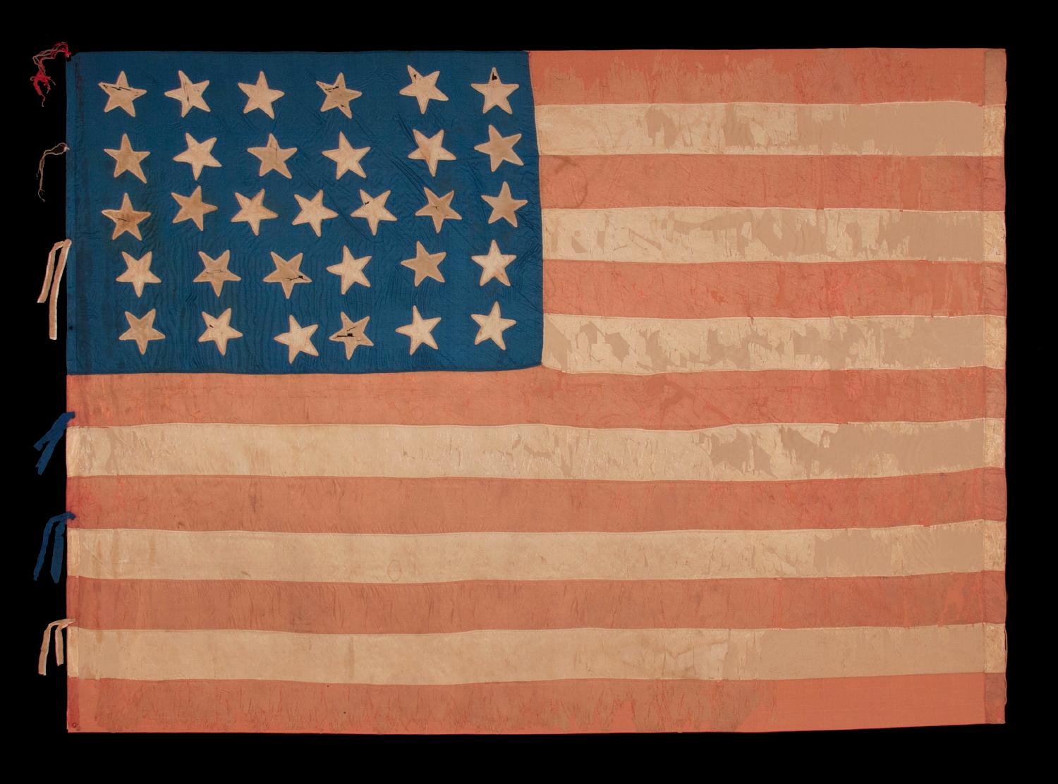 31 STARS IN A 6-6-7-6-6 LINEAL PATTERN, WITH SCATTERED ORIENTATION, ANTIQUE AMERICAN FLAG, MADE OF SILK AND WITH THE BLUE CANTON RESTING ON THE WAR STRIPE, CALIFORNIA STATEHOOD, 1850-1858, LIKELY HAND-CARRIED INTO THE CIVIL WAR BY A MILITIA UNIT